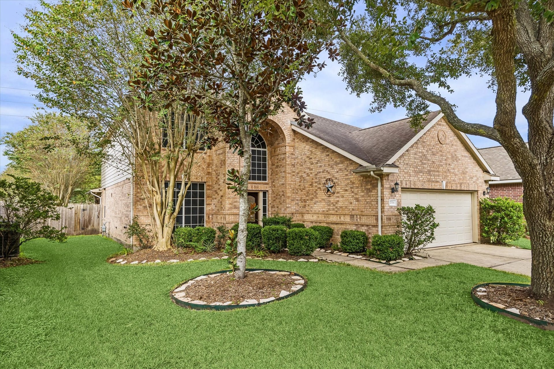7014 Baristone Lane, Richmond, TX 77407 Mature trees and lush landscaping enhance this home's inviting crub appel.