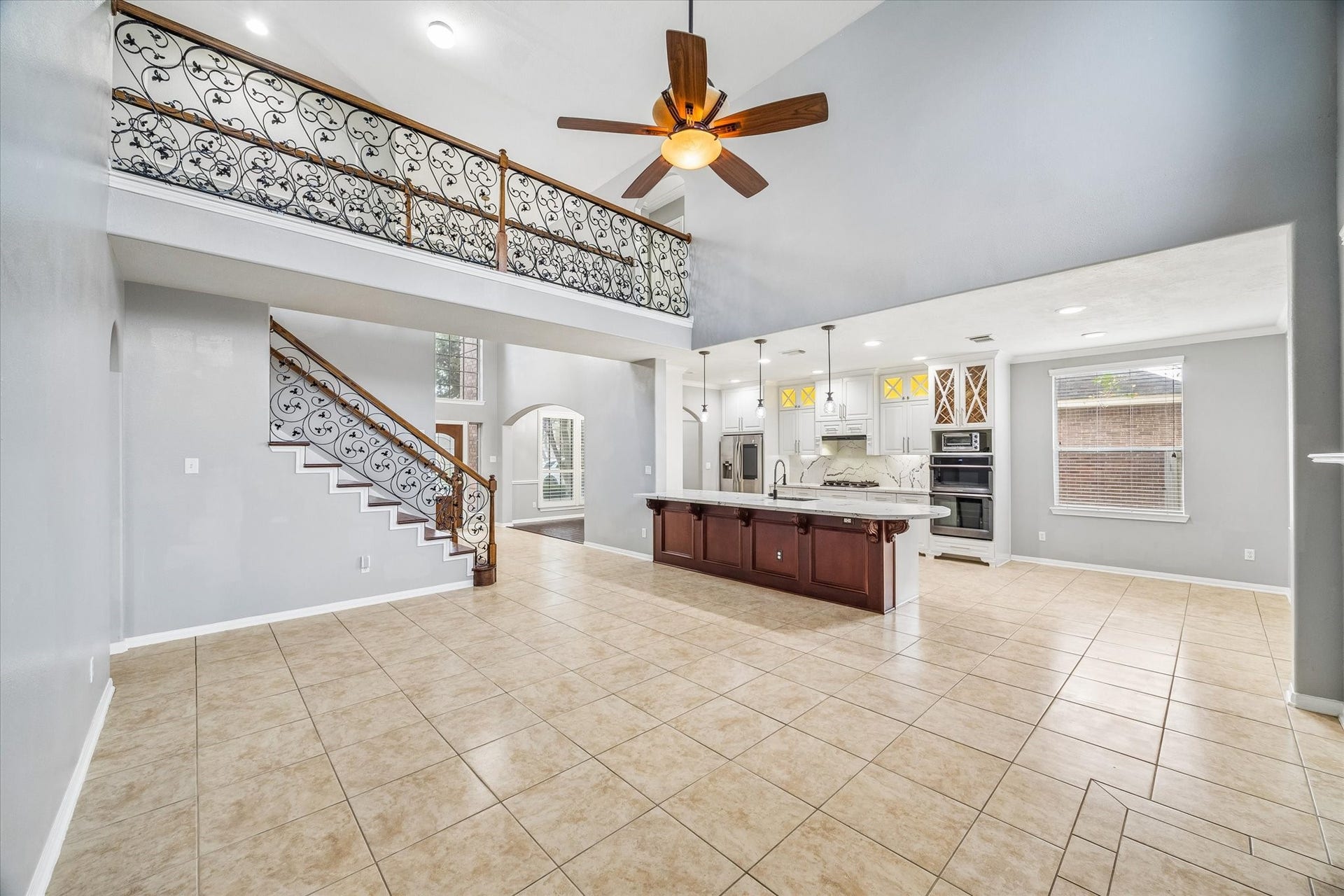7014 Baristone Lane, Richmond, TX 77407 Airy two-story living are opens to the kitchen, ideal for everyday living and entertaining.