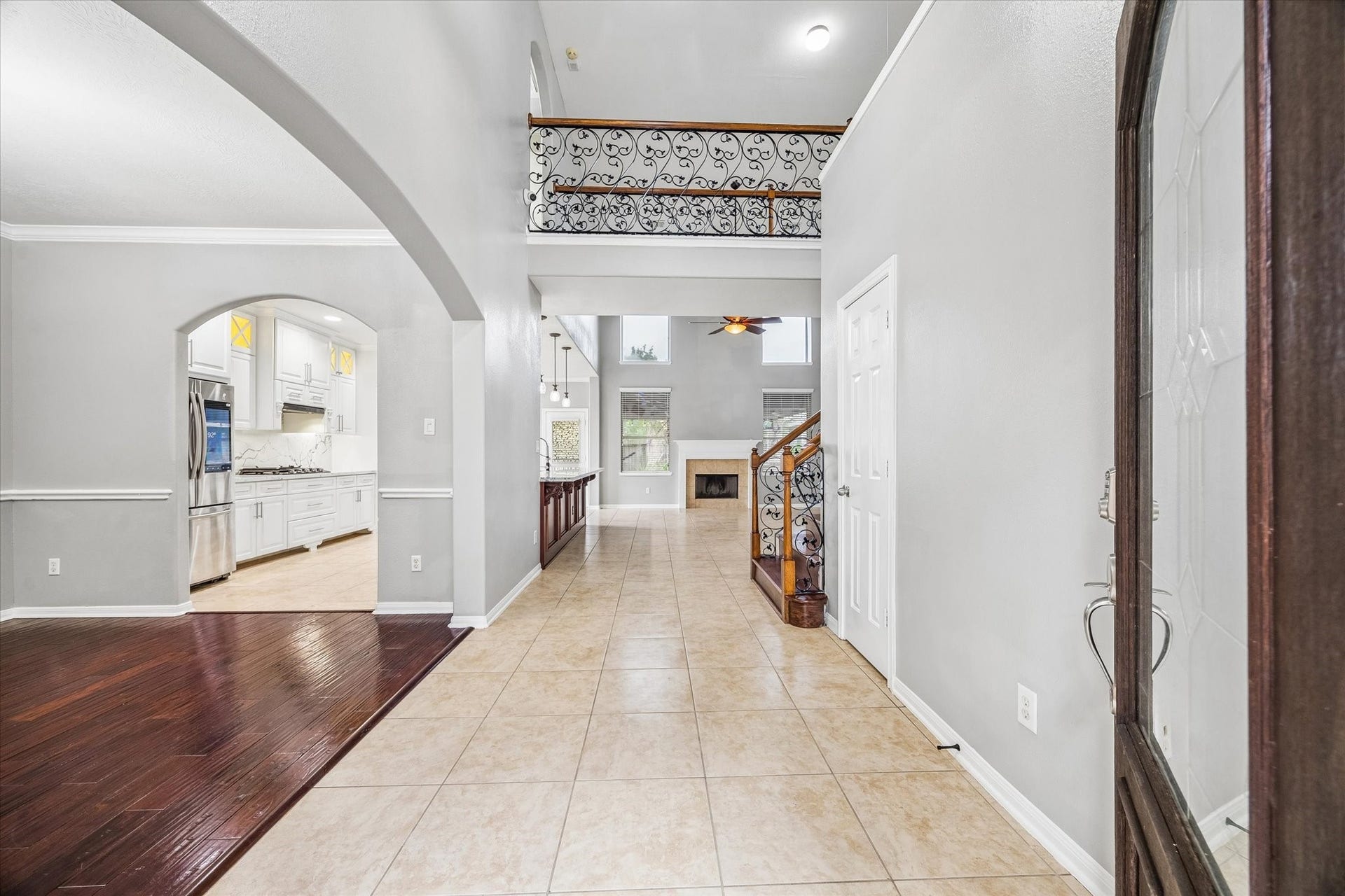 7014 Baristone Lane, Richmond, TX 77407 Welcoming foyer with tile flooring, soft gray tones, and elegant architectual details.