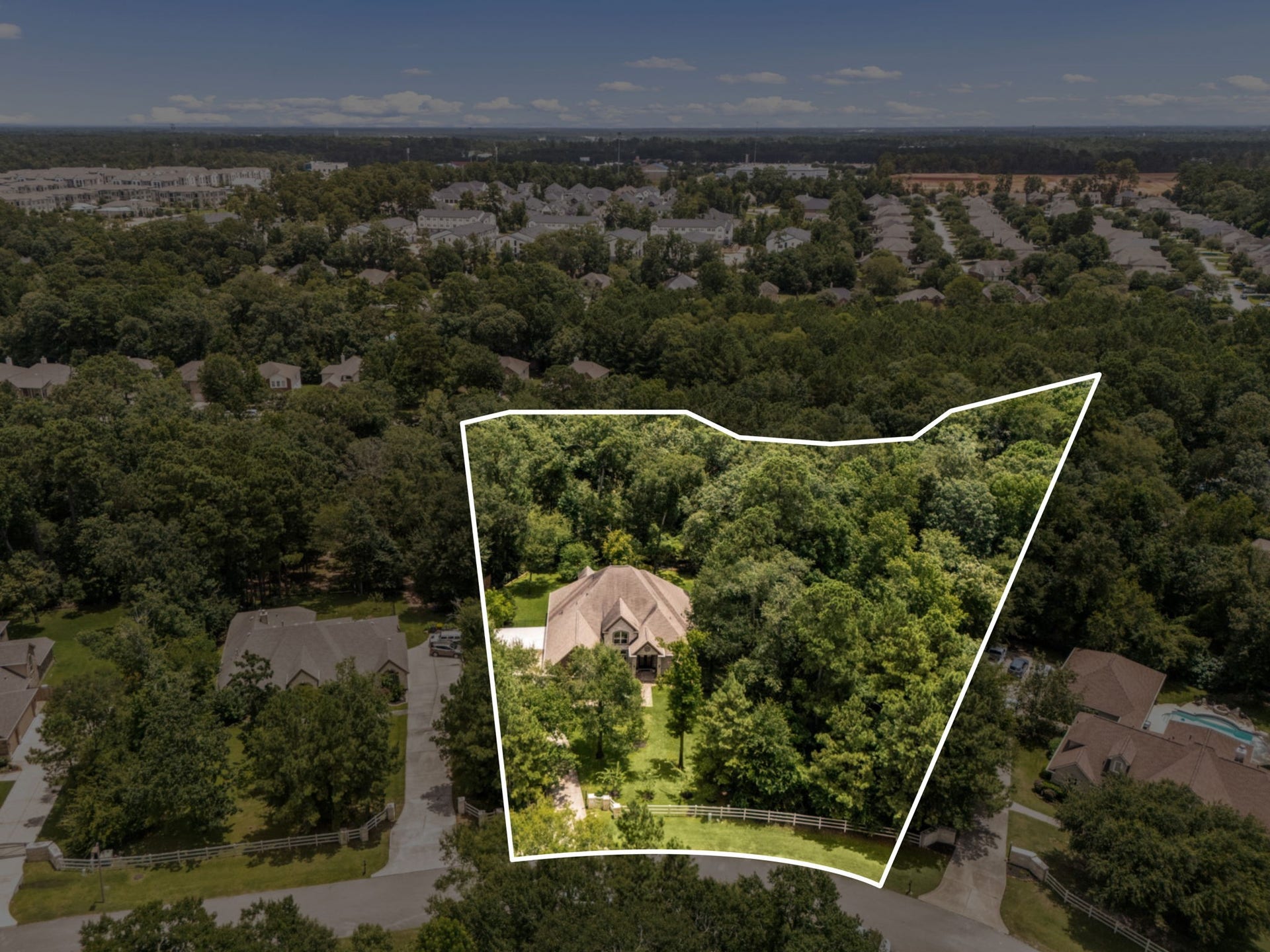 Aerial overview with lot line of 1904 Boulder Ridge, and adjoining acre also for sale, in Conroe.