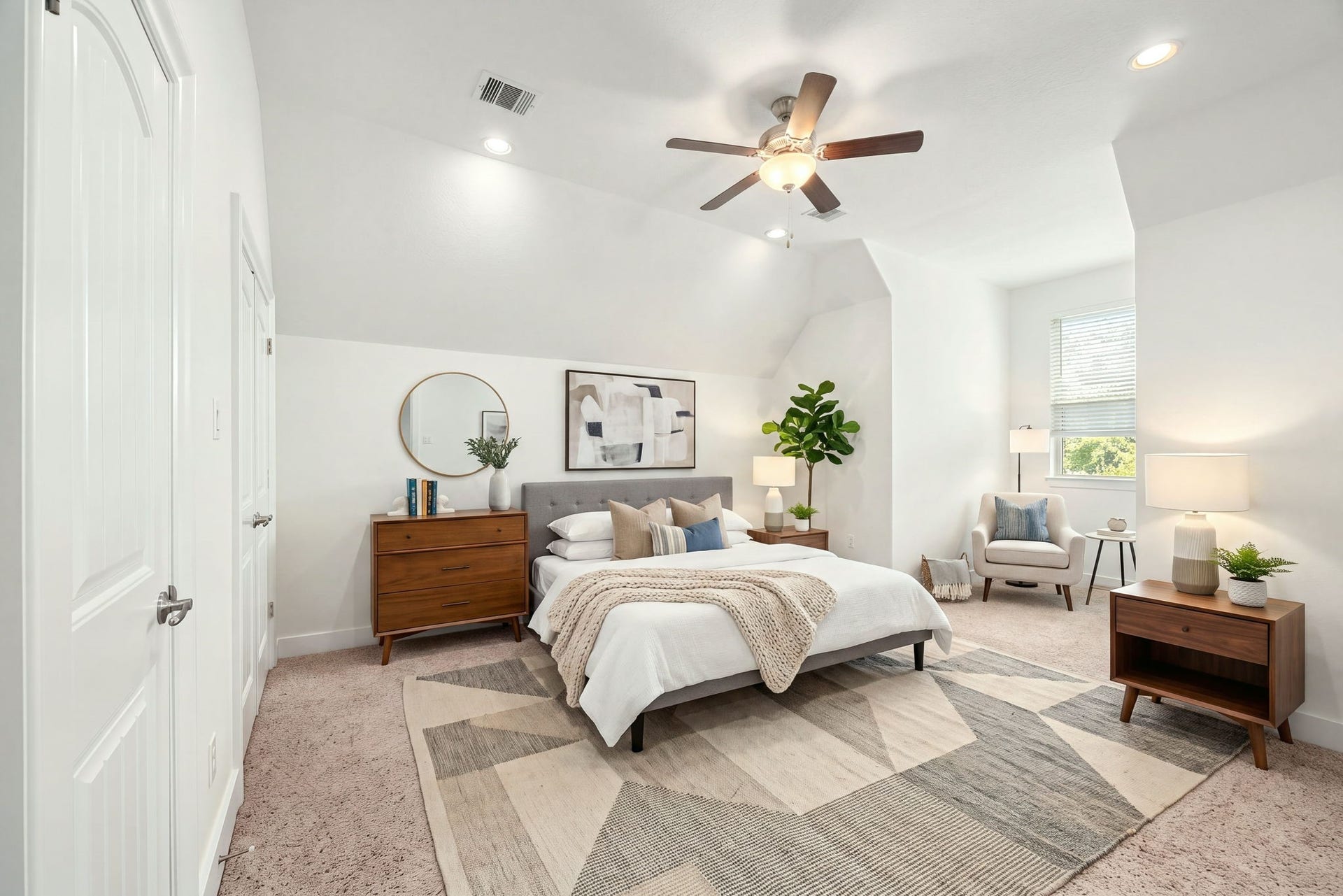 This spacious secondary bedroom features a dramatic vaulted ceiling complete with a central ceiling fan and recessed lighting. The bright room offers soft plush carpeting, a large window that invites plenty of natural light, and classic paneled doors leading to the closet. *Virtually Staged