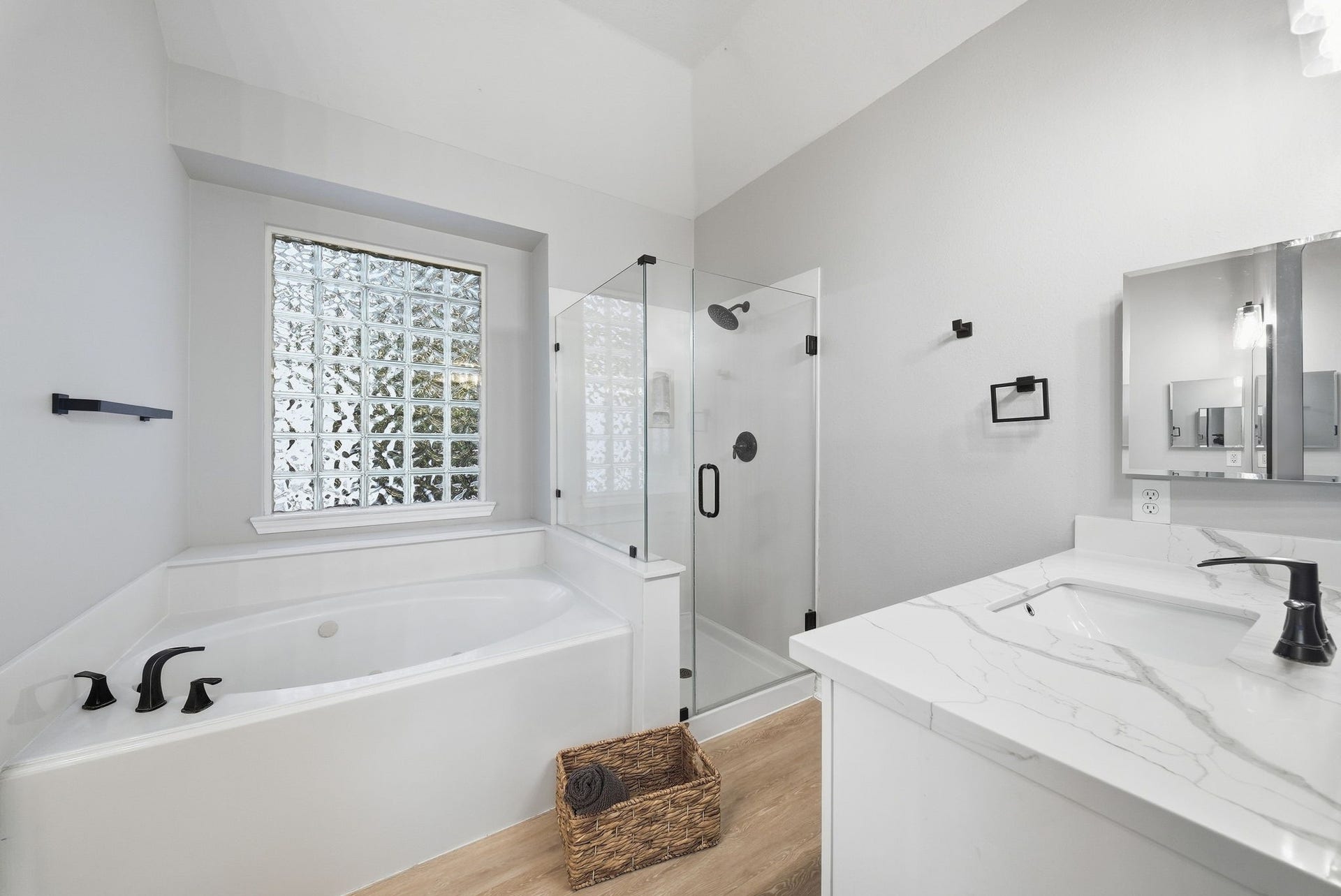 402 Prattwood Court, League City, TX 77573 Spacious bathroom with soaking tub, glass-enclosed walk-in shower, quartz vanity, and glass block window.