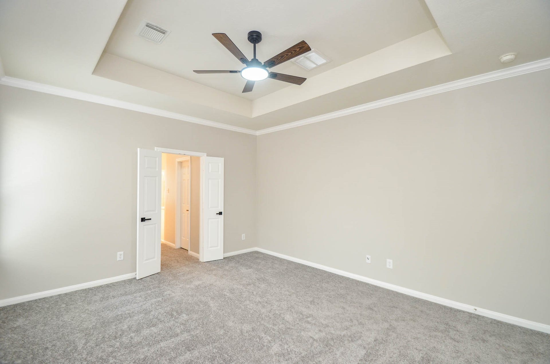 402 Prattwood Court, League City, TX 77573 Primary suite without furniture... doors lead to bathroom
