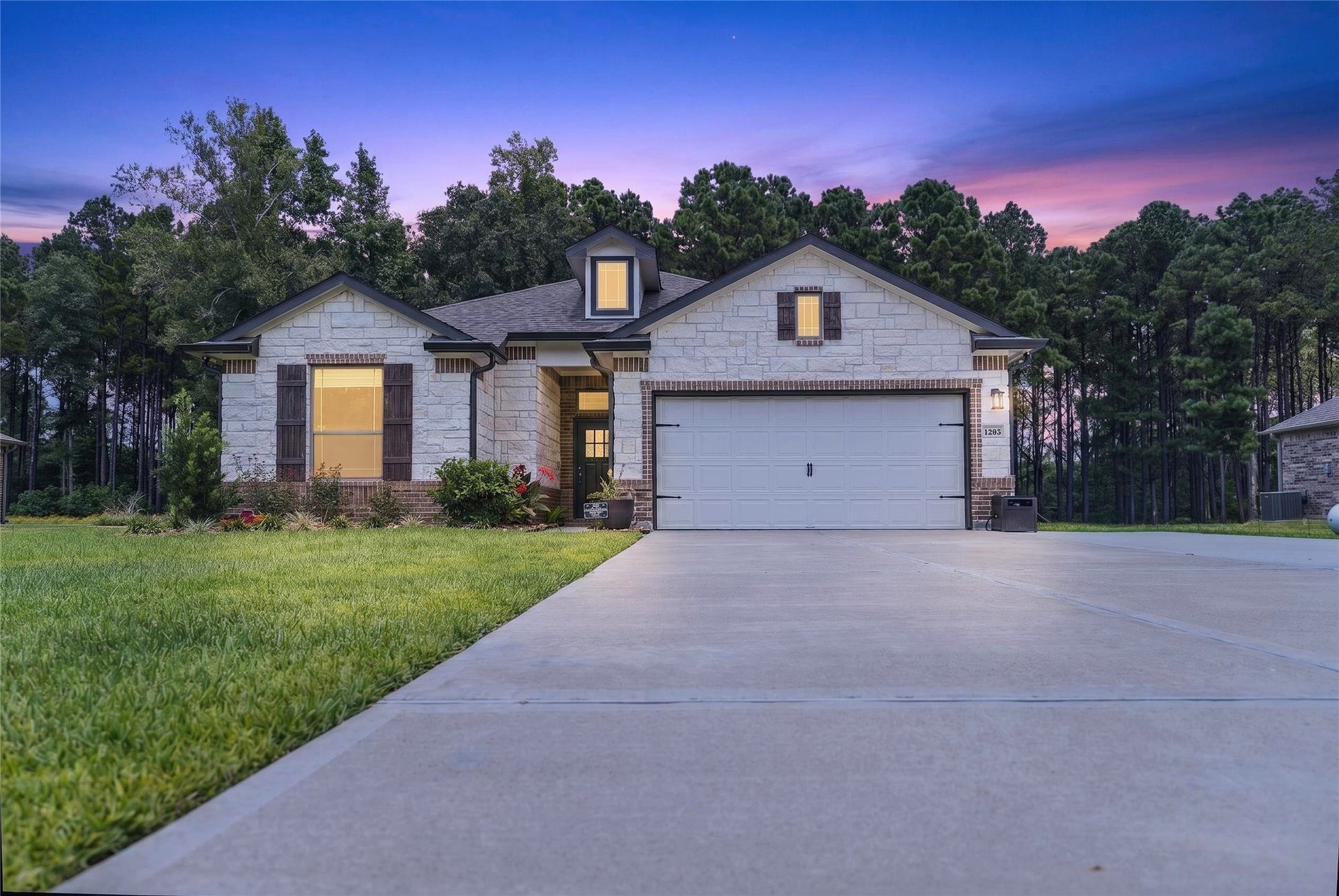 1295 Road 66112, Dayton, TX 77535 Main elevation with twilight effect