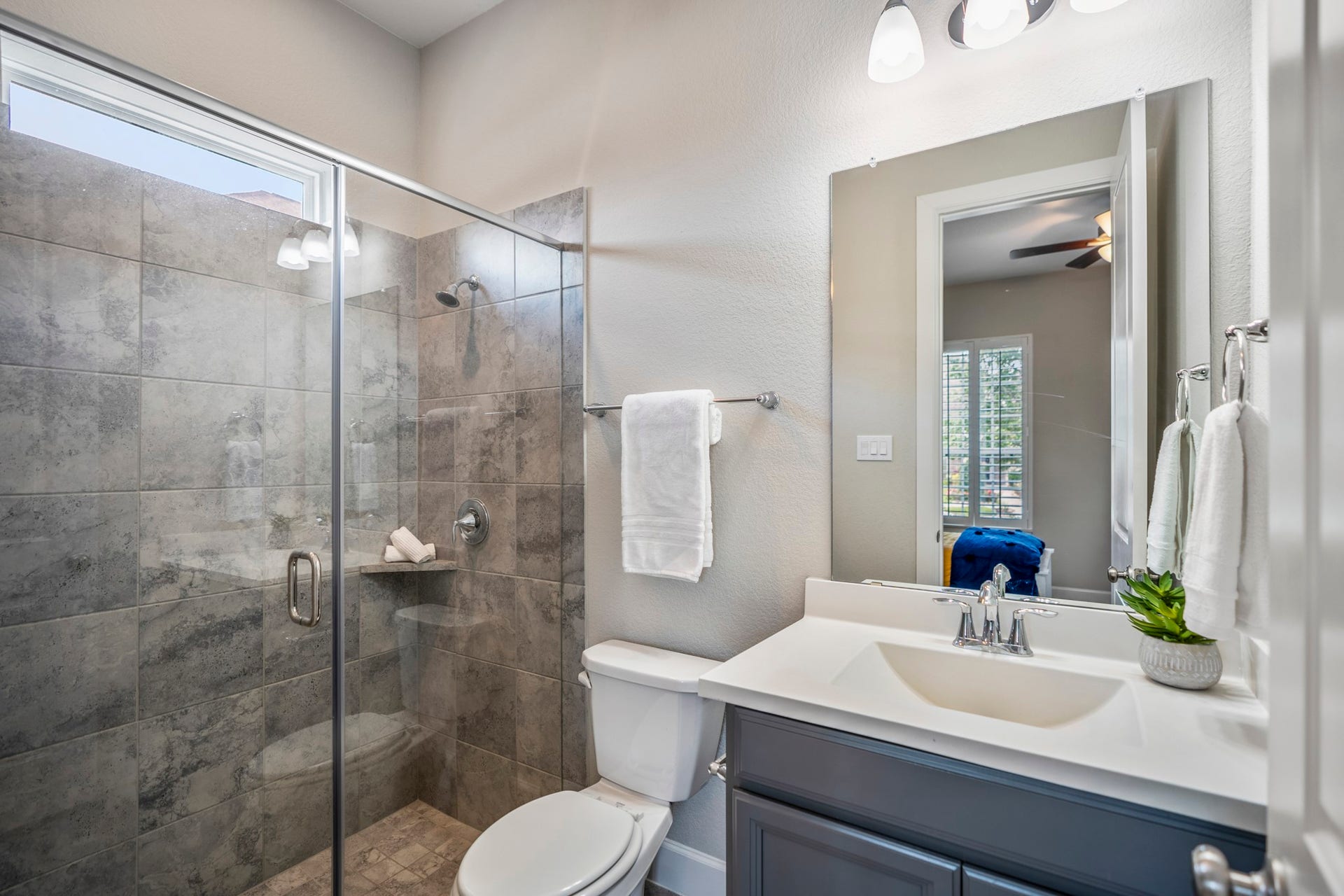 10615 Parkwood Court, Missouri City, TX 77459 Well-appointed en suite bathroom featuring an oversized walk-in glass shower, designer tile finishes, and a spacious vanity with ample storage. Thoughtfully designed to provide guests with both comfort and privacy.
