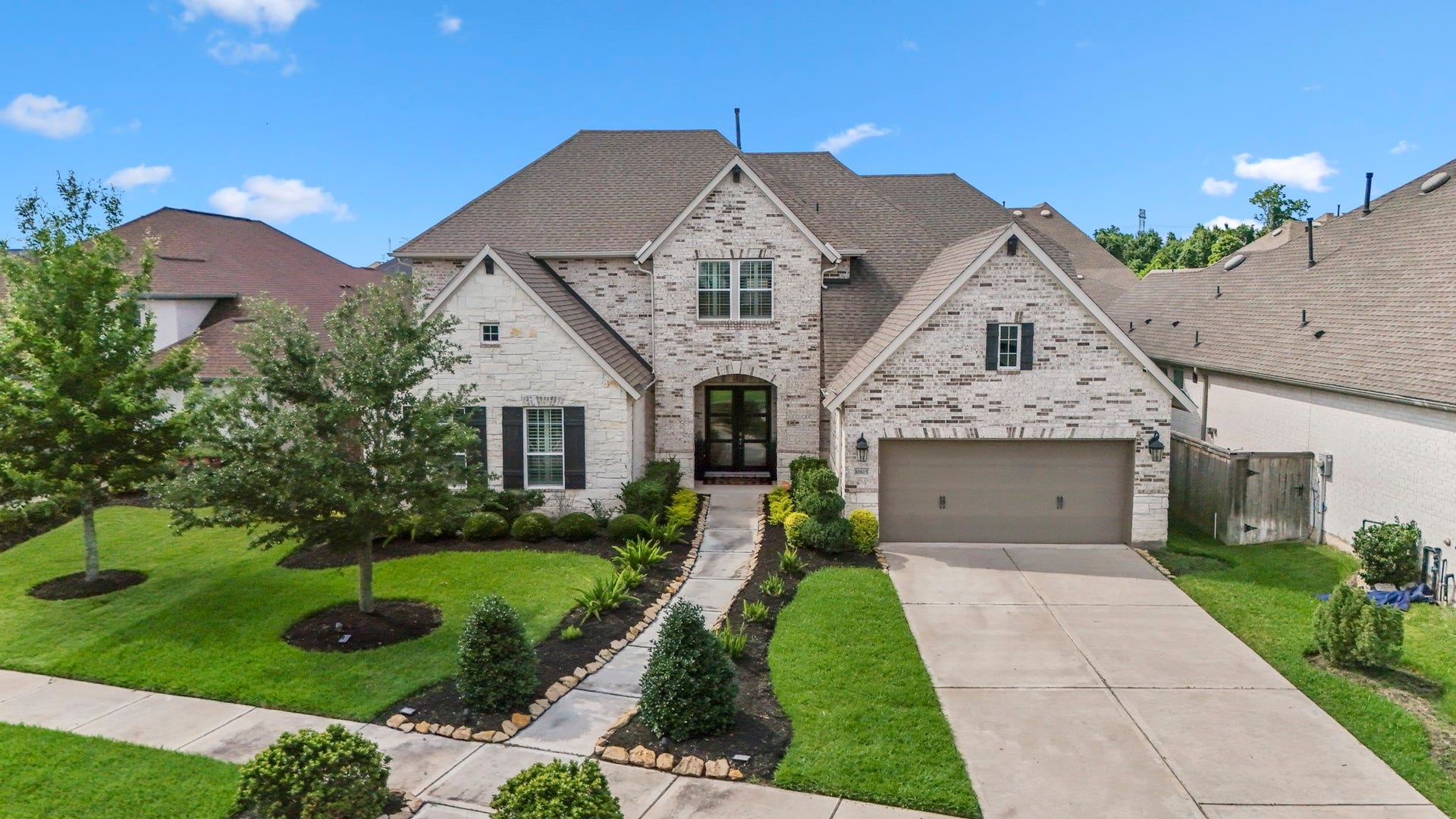 10615 Parkwood Court, Missouri City, TX 77459 Stunning brick and stone elevation with timeless architectural design, beautifully complemented by manicured landscaping and exceptional curb appeal.