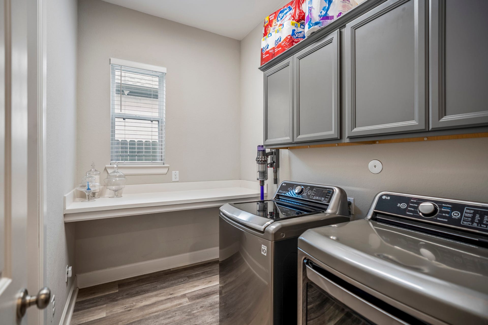 10615 Parkwood Court, Missouri City, TX 77459 Spacious laundry room designed with both style and functionality in mind, featuring abundant upper cabinet storage, expansive counter space for folding, and room for everyday organization. Thoughtful utility details make daily tasks both convenient and efficient.