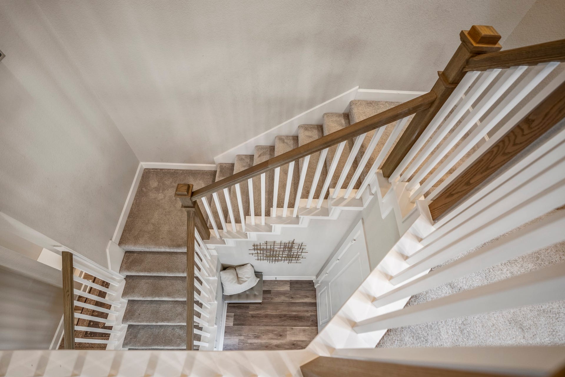 10615 Parkwood Court, Missouri City, TX 77459 Beautiful staircase design with contrasting wood accents and clean lines, creating a striking architectural feature that connects both levels with style and openness.
