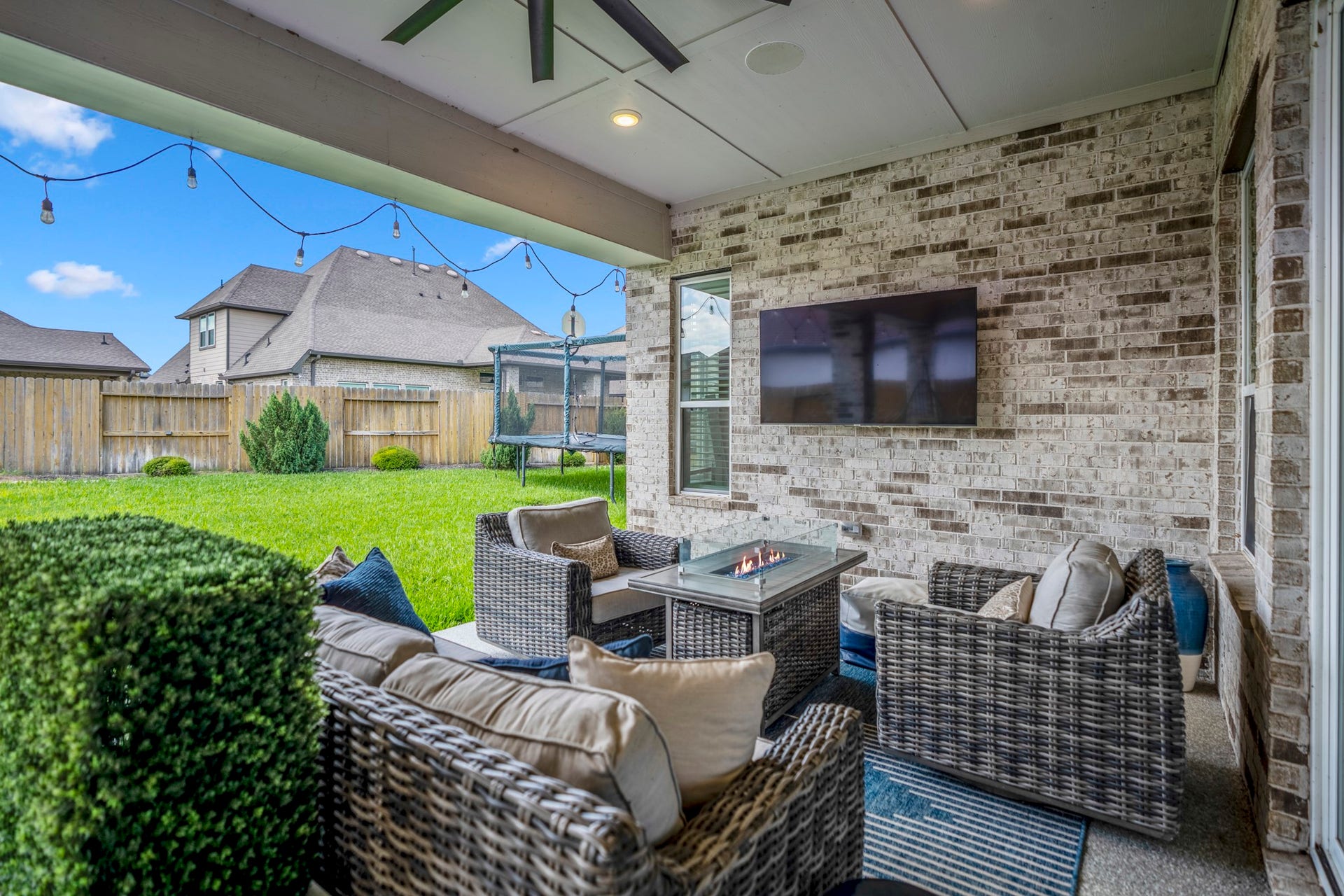 10615 Parkwood Court, Missouri City, TX 77459 Covered outdoor living space designed for relaxing evenings and effortless entertaining, complete with plenty of room for seating and views of the spacious backyard.