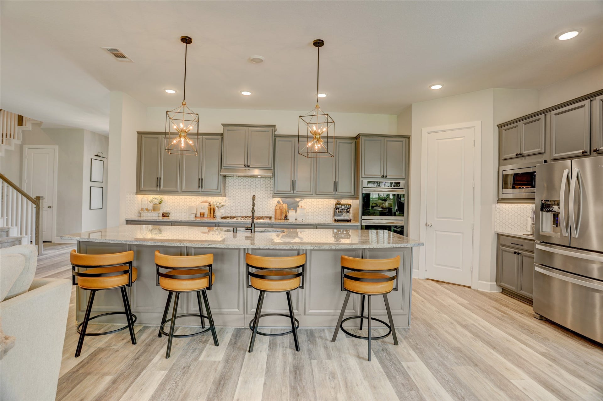 10615 Parkwood Court, Missouri City, TX 77459 Chef-inspired kitchen featuring stunning custom pendant lighting, under-cabinet illumination, and an oversized island designed for gathering and entertaining. Beautiful cabinetry, expansive prep space, and designer finishes create a sophisticated yet highly functional heart of the home.