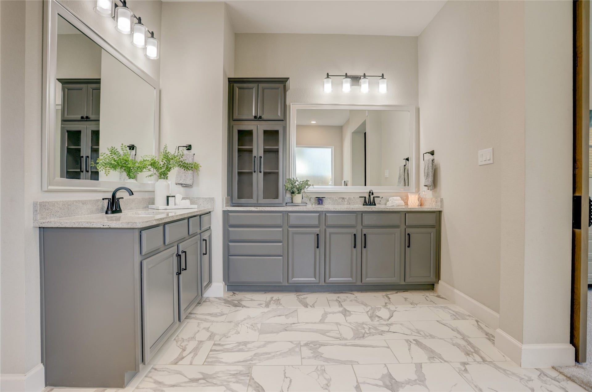 10615 Parkwood Court, Missouri City, TX 77459 Spa-inspired primary bathroom featuring dual vanities, abundant cabinetry, and elegant marble-look tile flooring that elevates the space with a clean, luxurious feel. Thoughtfully designed with generous storage, expansive counter space, and a seamless connection to the primary suite for everyday comfort and convenience.
