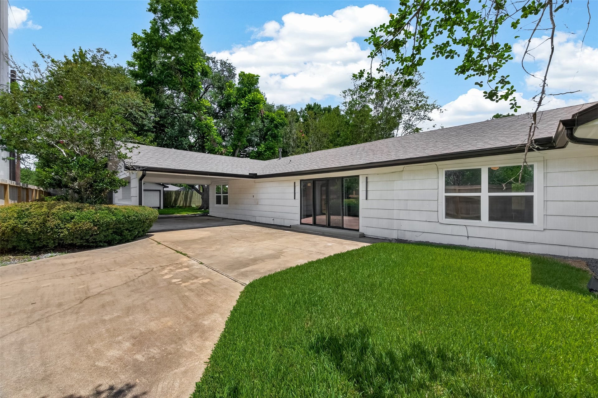 5422 Valerie Street, Bellaire, TX 77401 This west side area of the property is currently fenced and closed off, offering added privacy and flexibility for future use. The covered carport provides potential to be converted into a two-car garage, if desired, while the area just outside the primary bedroom could be enhanced as an additional outdoor living space, private lounge, or garden retreat. A great opportunity to reimagine this side of the property to fit your lifestyle and needs.
