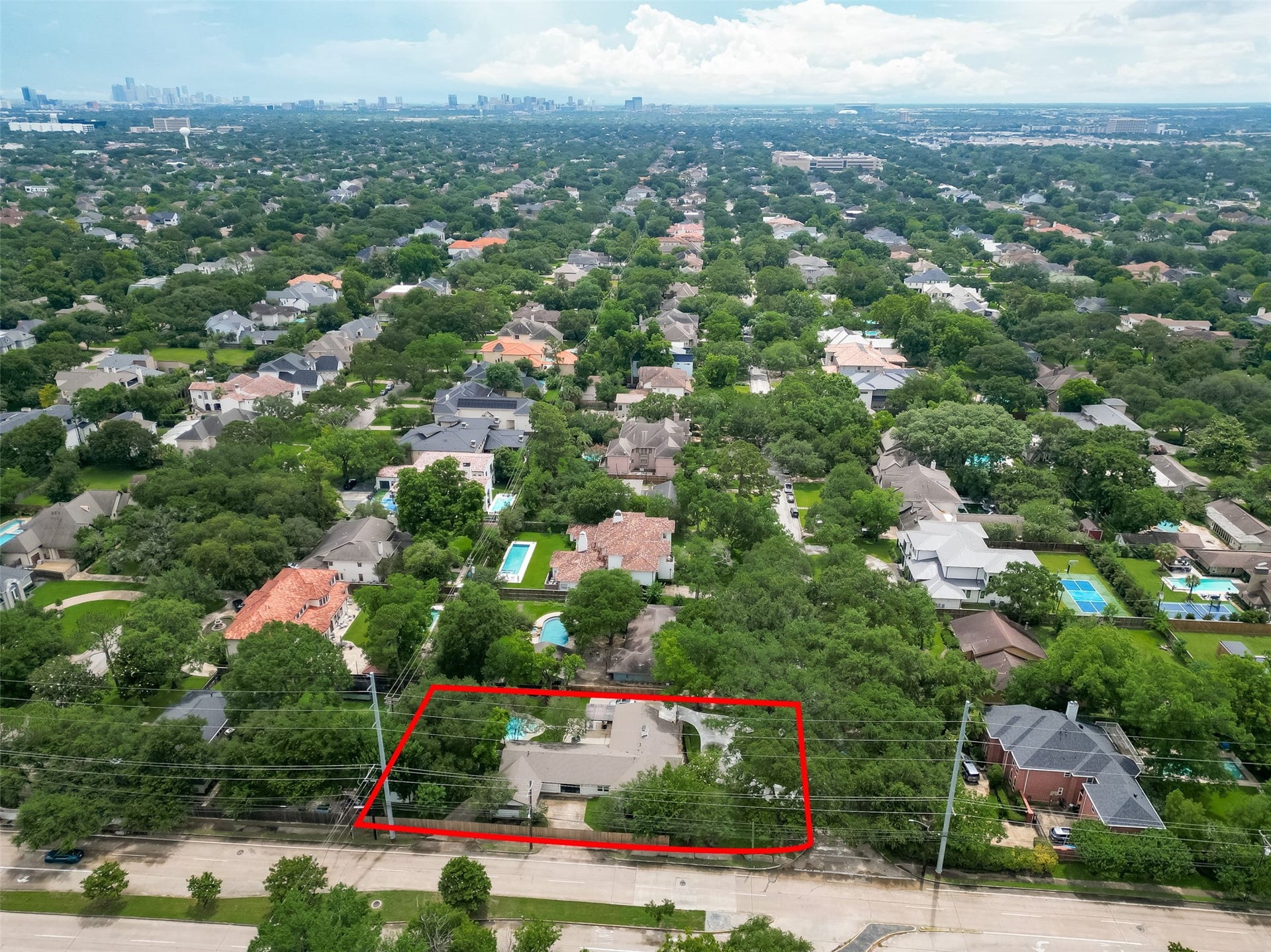 5422 Valerie Street, Bellaire, TX 77401 Aerial view highlighting 5422 Valerie St. outlined in red, with a distant city skyline showcasing convenient access to the Bellaire Recreation Center, the library and the wonderful parks.