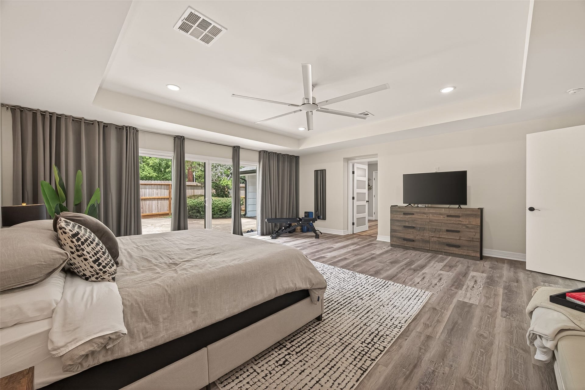 5422 Valerie Street, Bellaire, TX 77401 The expansive primary suite features vaulted ceilings, recessed lighting, and a designer fan for a refined touch. One of the owners favorite features is the thoughtful floor plan, with the primary bedroom and private office positioned in their own separate wings, offering added privacy from the secondary bedrooms.