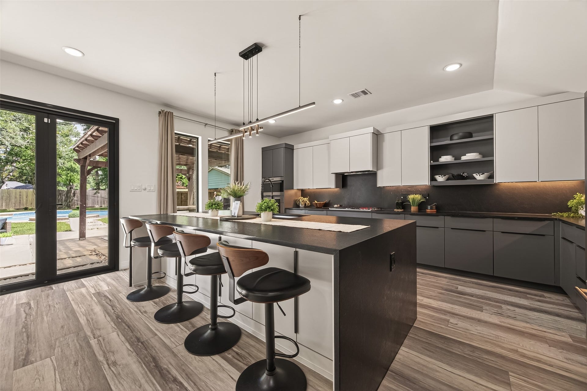 5422 Valerie Street, Bellaire, TX 77401 The kitchen island features bar seating, ideal for casual dining, conversation, and everyday living within the homes open-concept layout.