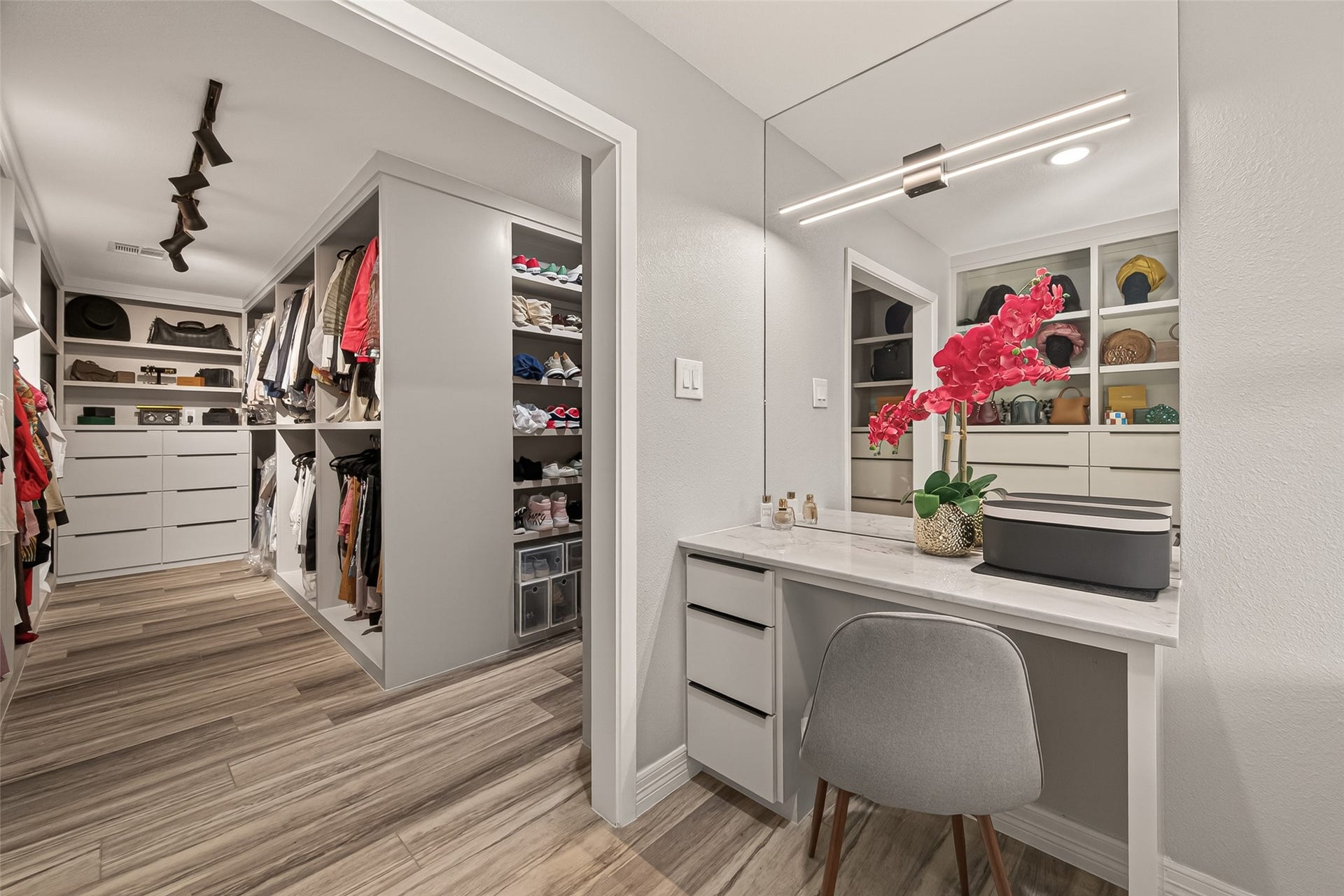 5422 Valerie Street, Bellaire, TX 77401 Chic, sleek vanity area with generous counter space and abundant storage. A large mirror and modern lighting enhance both function and style, creating a polished, well-designed space.