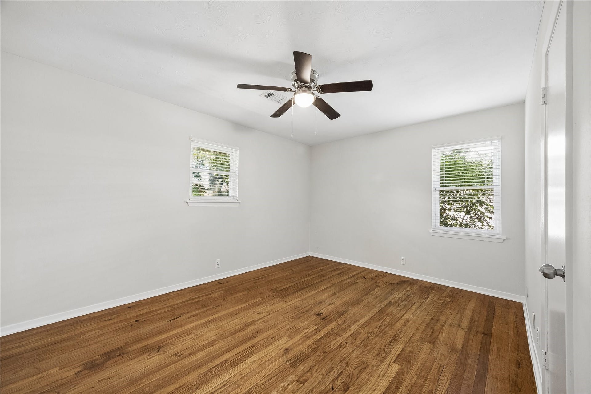 7824 Yucca Drive, Texas City, TX 77591 Bedroom 2 with neutral paint and wood floors.