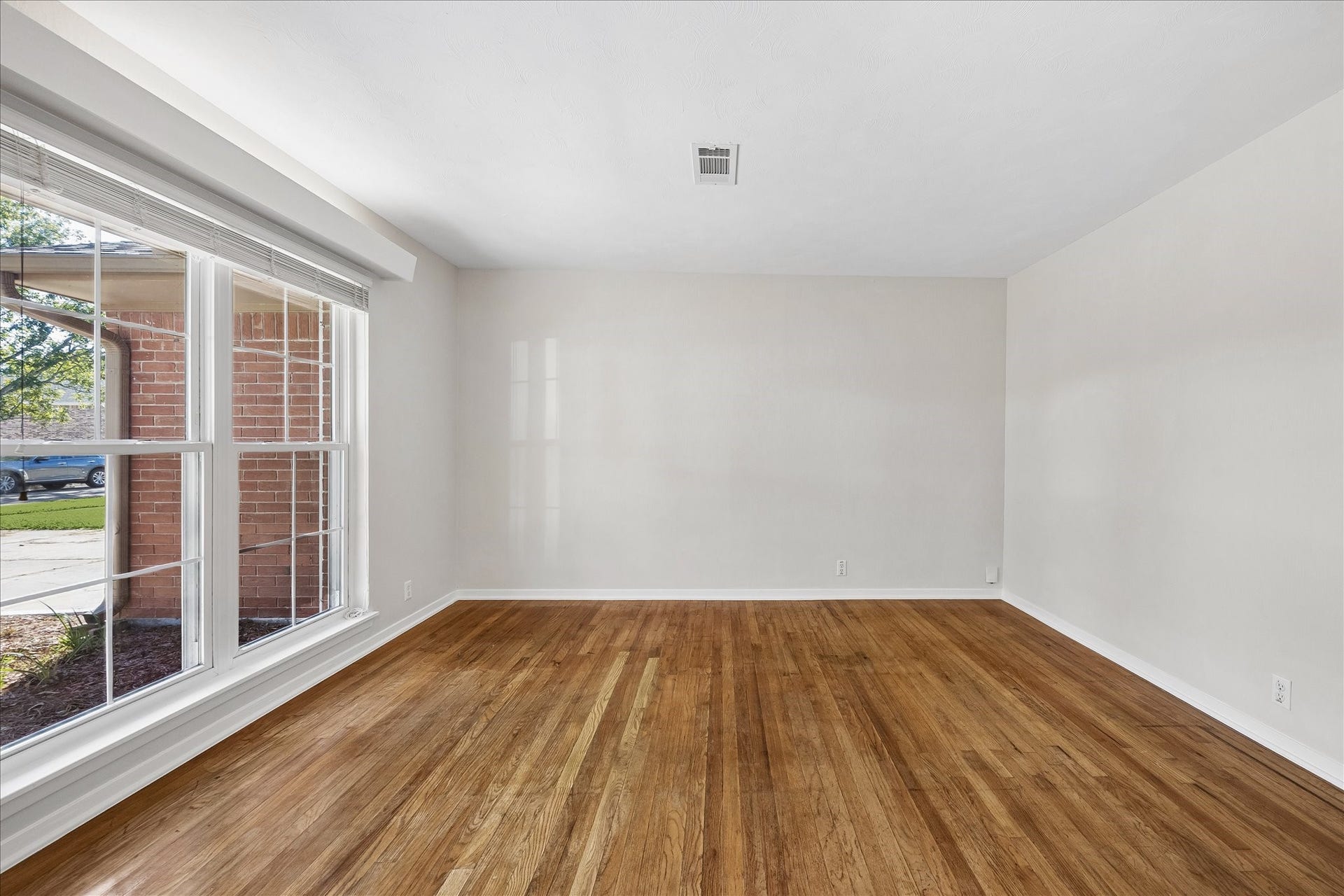 7824 Yucca Drive, Texas City, TX 77591 This room features hardwood floors and windows that let in natural light.