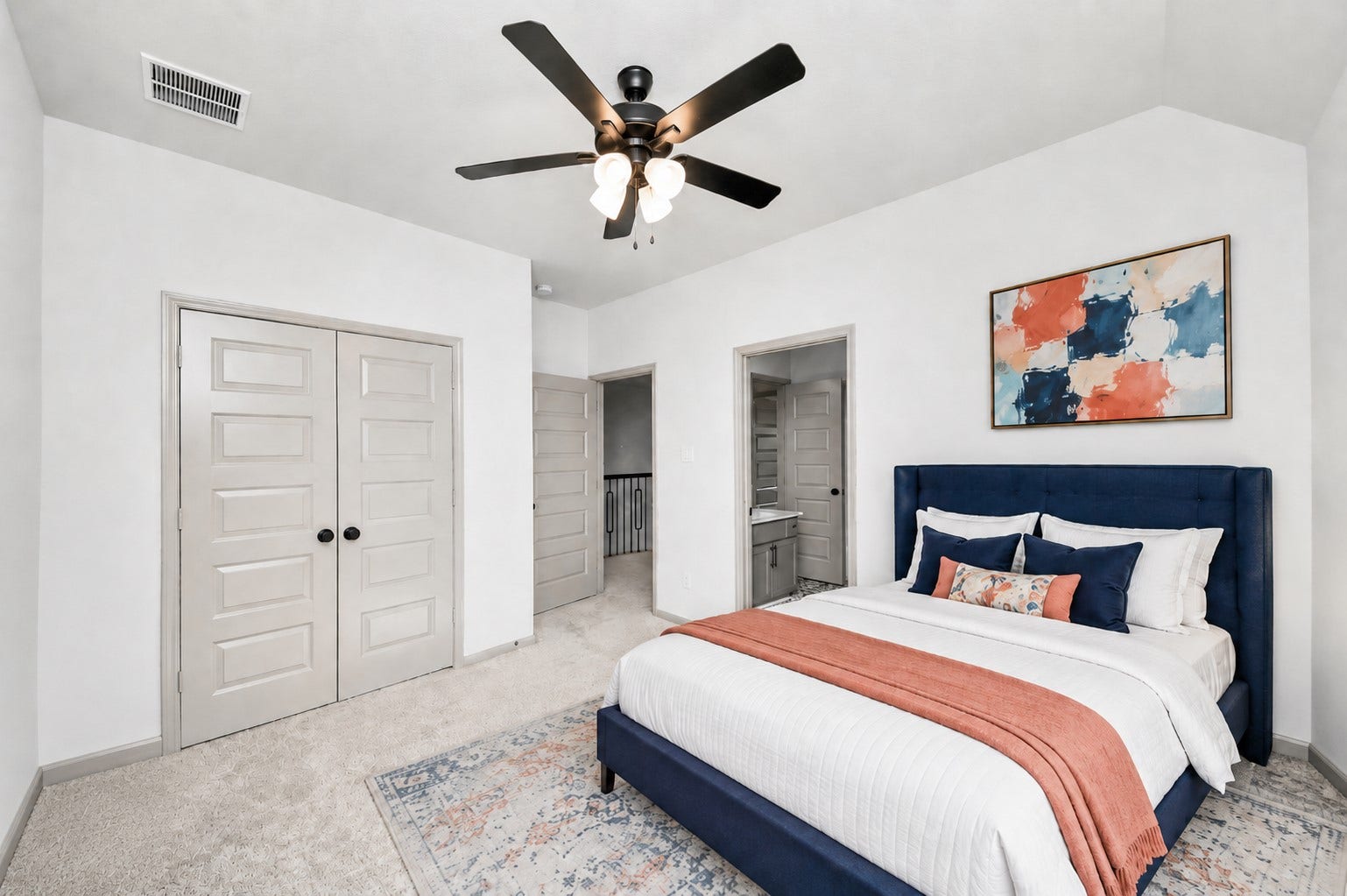 1423 Hackberry Heights Drive, Richmond, TX 77406 Virtually staged. Discover a beautifully bright bedroom featuring a chic, virtually staged design with a plush bed, modern ceiling fan, and vibrant artwork, promising comfort and style.
