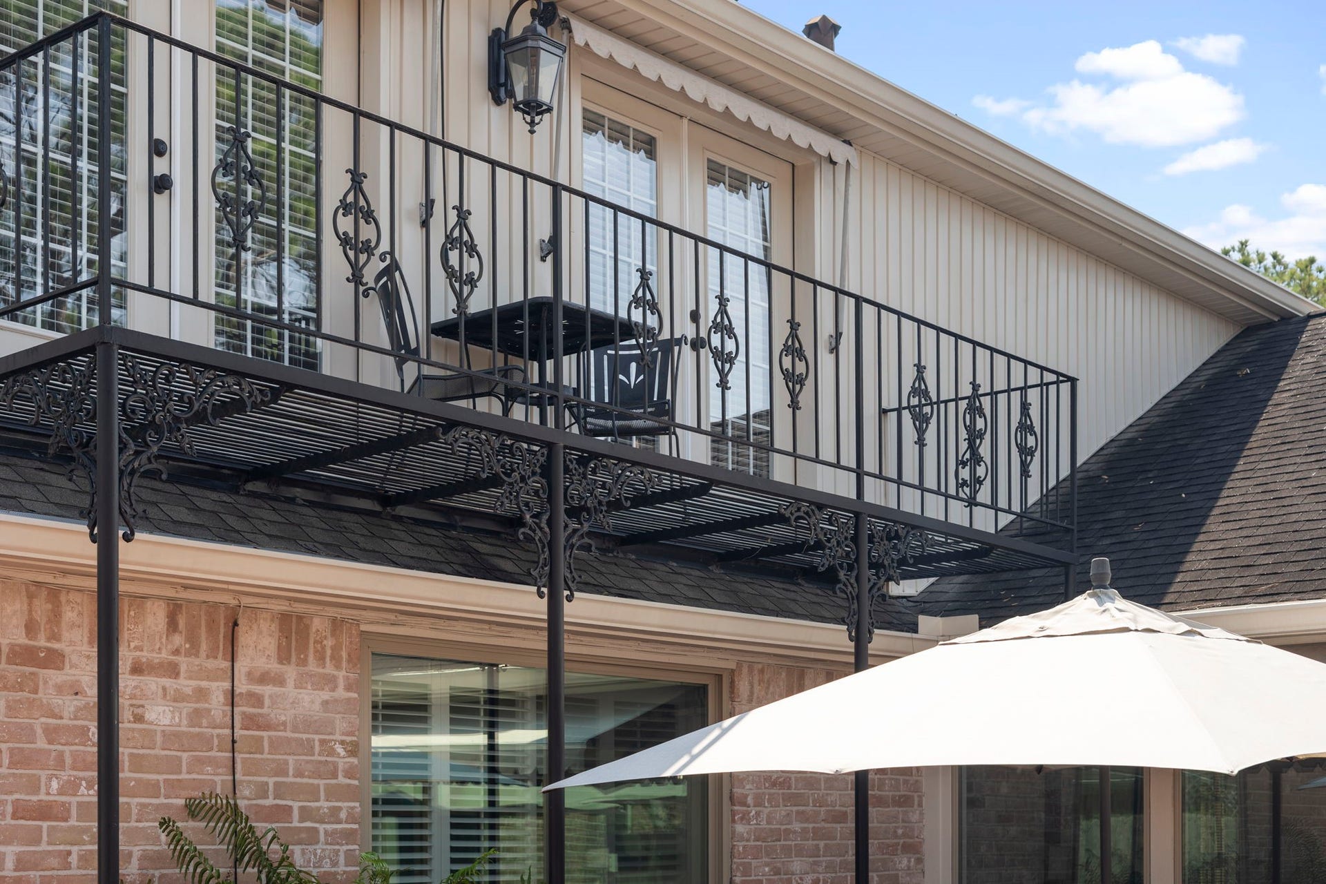 443 Fox Briar Lane, Sugar Land, TX 77478 French doors open from the game room to a private balcony overlooking the courtyard, creating an inviting connection to the outdoors.