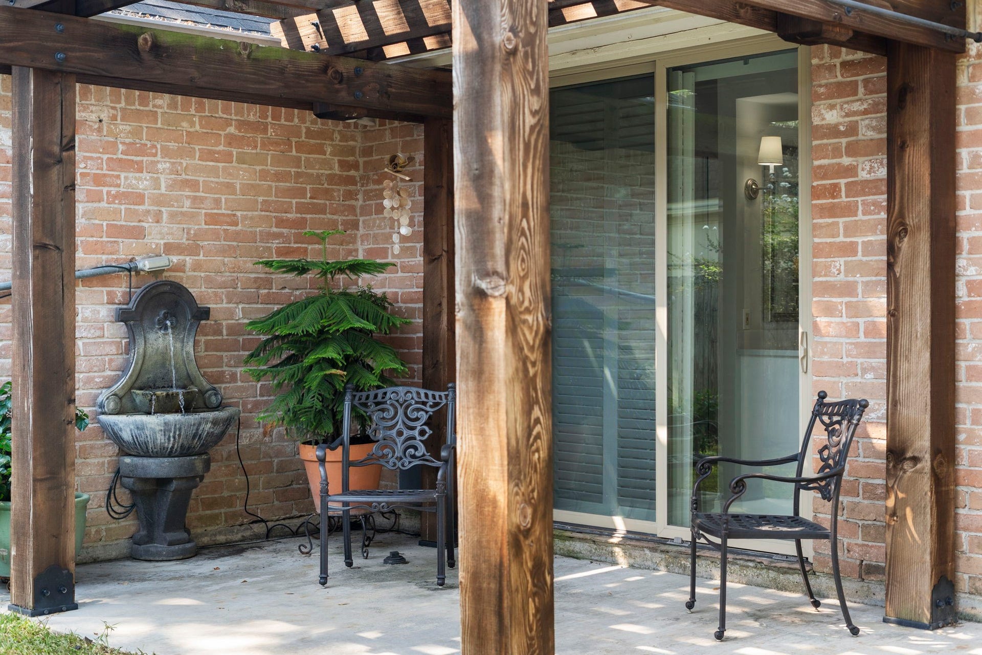 443 Fox Briar Lane, Sugar Land, TX 77478 A private patio with a pergola and fountain offers a peaceful retreat just outside the owners suite.