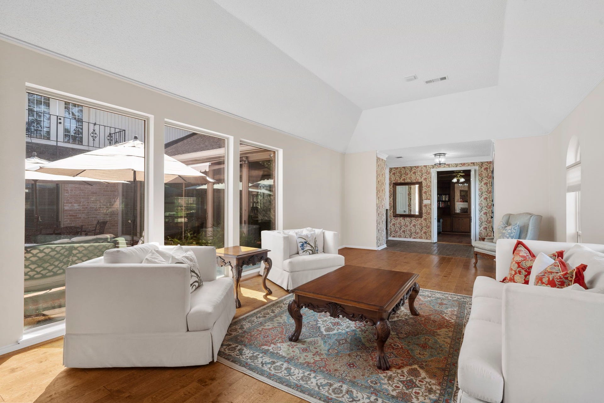 443 Fox Briar Lane, Sugar Land, TX 77478 Enjoy tranquil views from the light-filled living room, where rich hardwood flooring adds warmth and character.