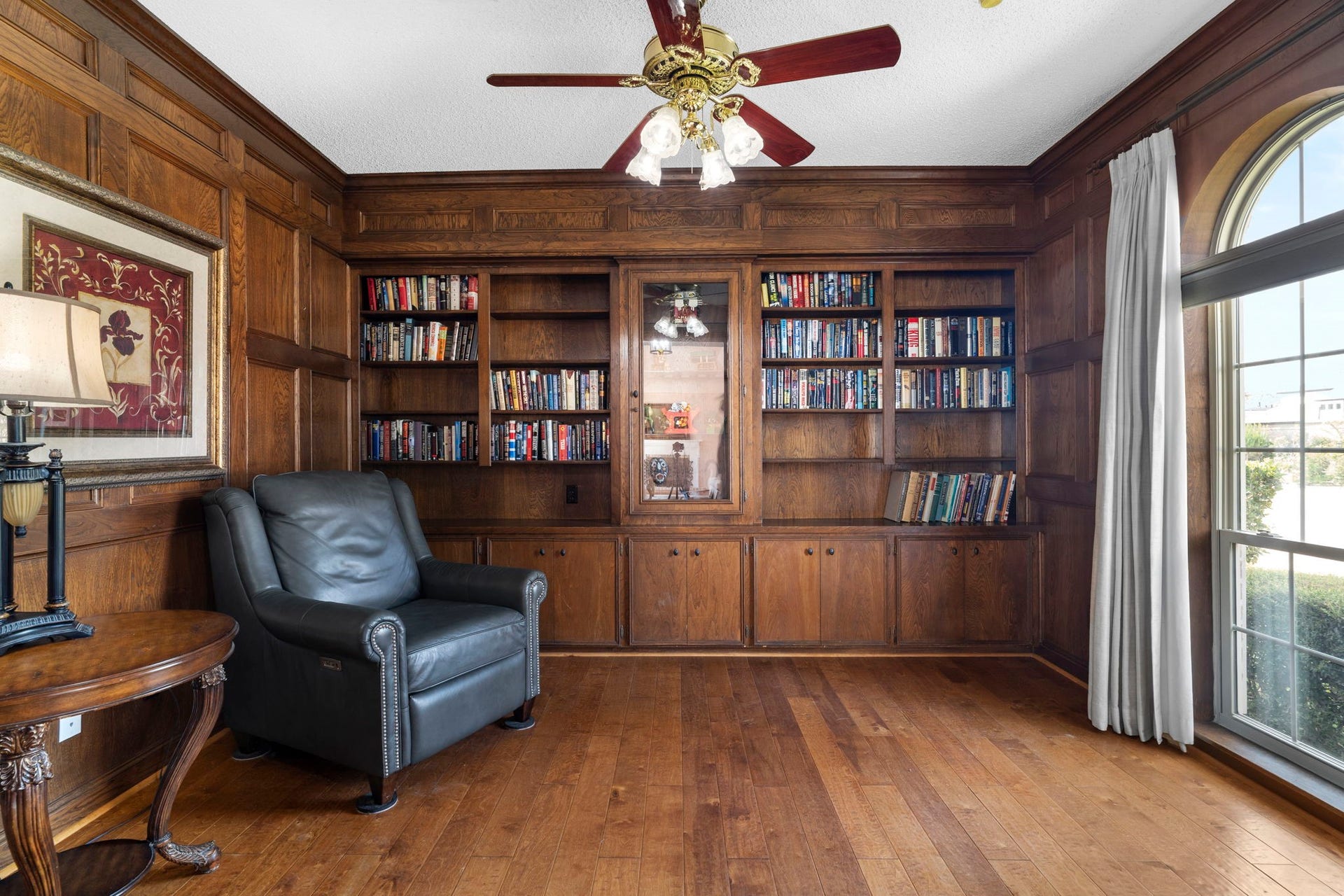 443 Fox Briar Lane, Sugar Land, TX 77478 With its paneled wood walls, rich flooring, and wall of custom cabinetry, this handsome study has the feel of a refined library. A large arched window brings in natural light, while French doors provide a quiet sense of separation from the rest of the home.