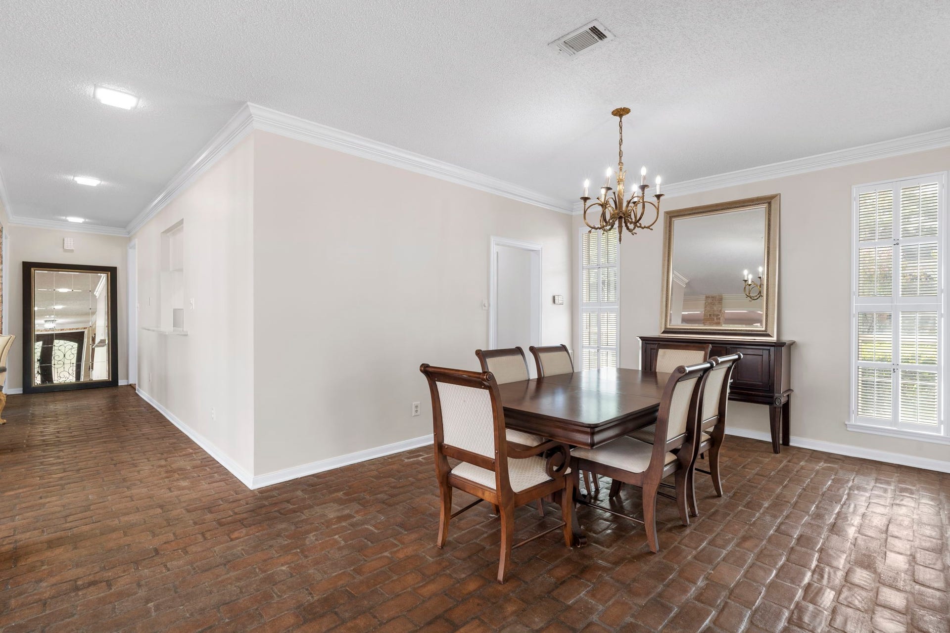 443 Fox Briar Lane, Sugar Land, TX 77478 The dining room is ideally positioned between the kitchen and family room and features tall windows with louvered shutters.