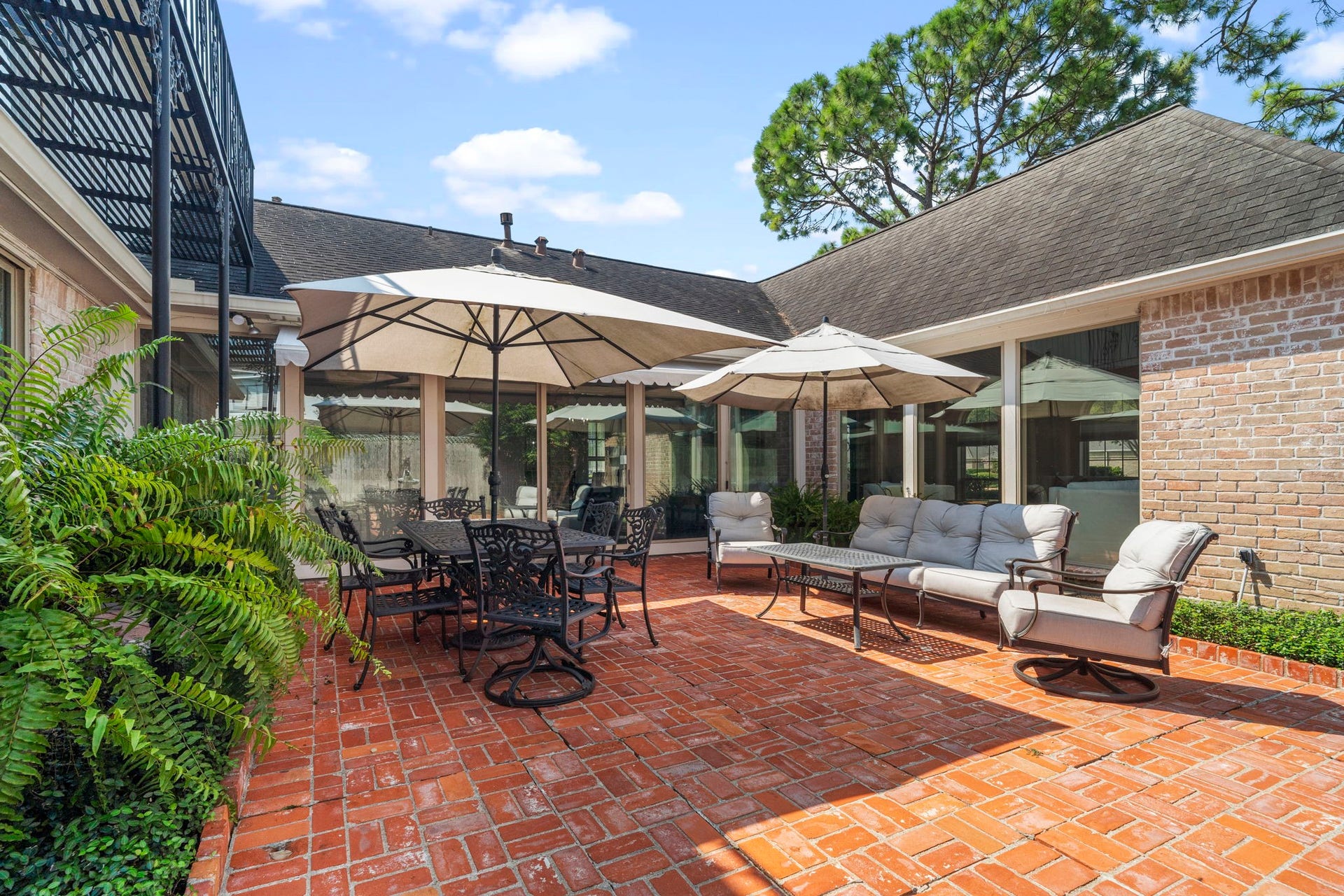 443 Fox Briar Lane, Sugar Land, TX 77478 The private courtyard is a true retreat, complete with a beautiful fountain, brick pavers, mature landscaping, and a charming wrought-iron balcony.
