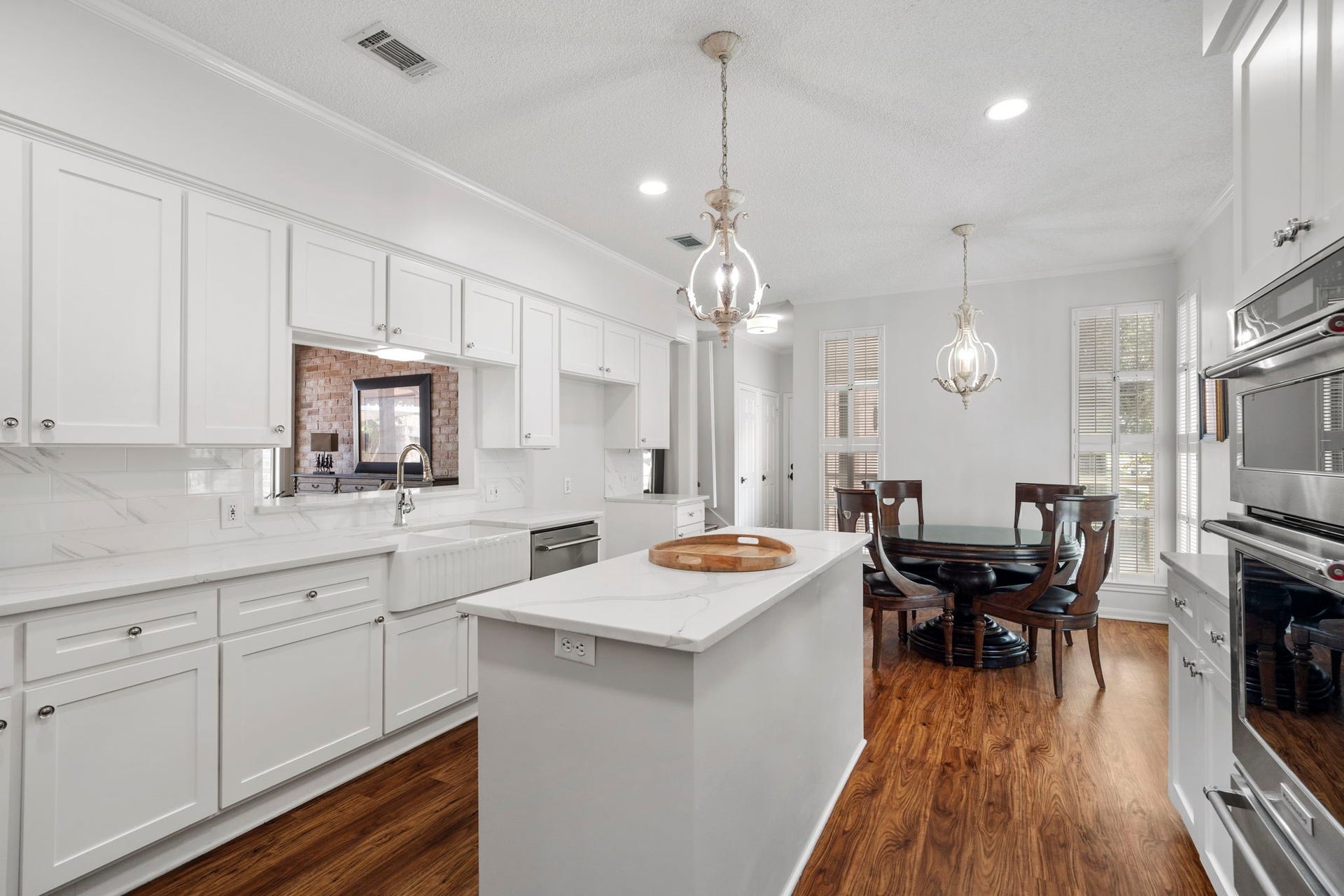 443 Fox Briar Lane, Sugar Land, TX 77478 Recessed lighting and French Country-style LED pendants provide the kitchen with bright, layered illumination.