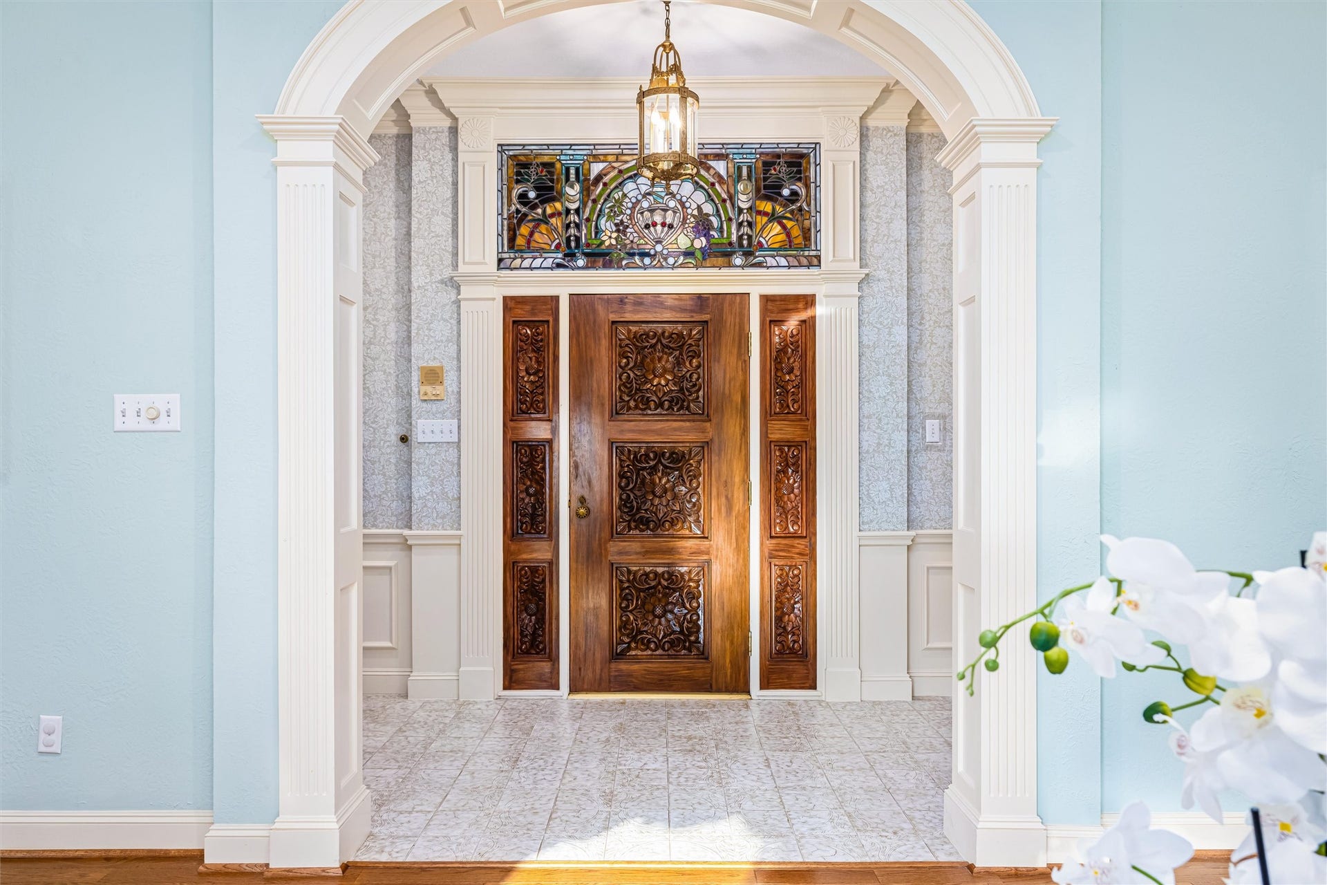 1715 Avenue D, Katy, TX 77493 Extraordinary craftsmanship is showcased in the custom carved wood entry and stained-glass transom.