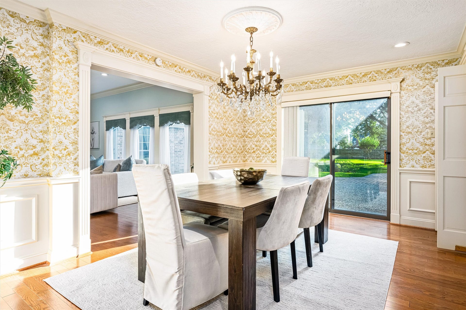 1715 Avenue D, Katy, TX 77493 Awaiting your memorable gatherings, the formal dining room is rich with hardwood floors, elegant millwork, and backyard views with direct access to the back patio through double sliding doors.