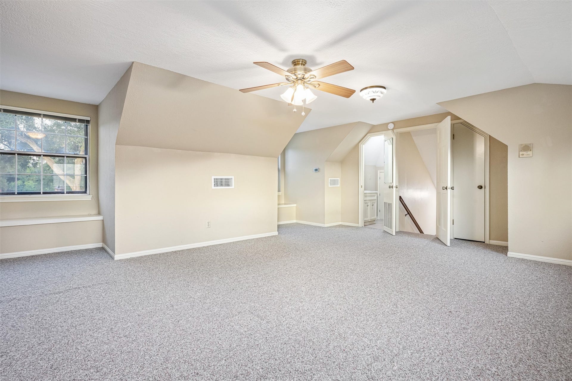 1715 Avenue D, Katy, TX 77493 The upstairs guest suite includes a convenient half bath, walk-in closet and private staircase, creating a comfortable retreat for guests, extended family or flexible living.