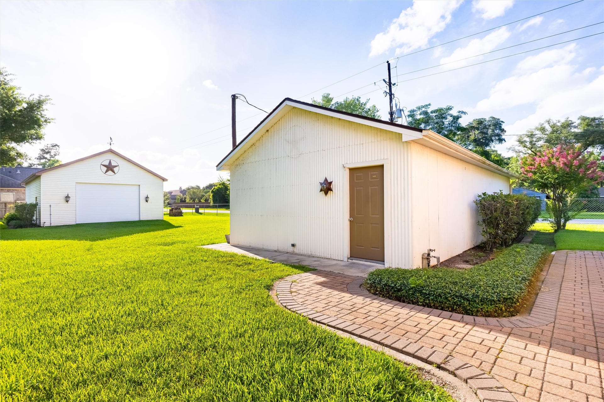 1715 Avenue D, Katy, TX 77493 Sweeping paved walkways lead to the detached air-conditioned workshop, a remarkable extension of this thoughtfully designed estate.
