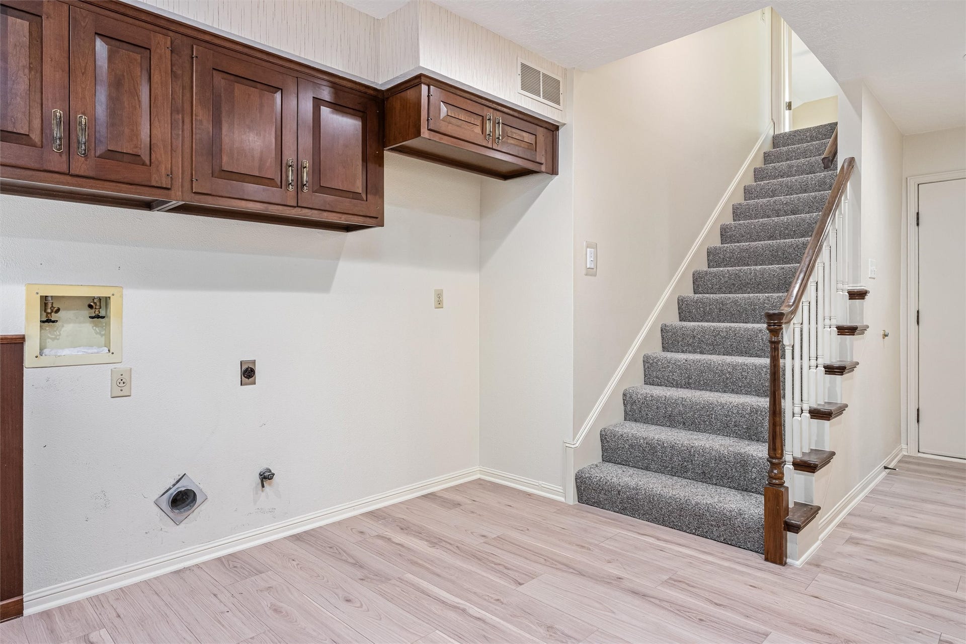 1715 Avenue D, Katy, TX 77493 More than a laundry room, this oversized utility space is complete with abundant cabinetry, a room for an additional refrigerator/freezer and convenient access to the upstairs guest suite.