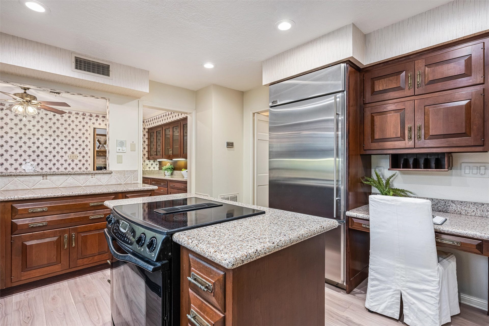 1715 Avenue D, Katy, TX 77493 Kitchen includes a built-in Monogram refrigerator, dedicated planning desk, abundant cabinetry and generous workspace for everyday living and entertaining.