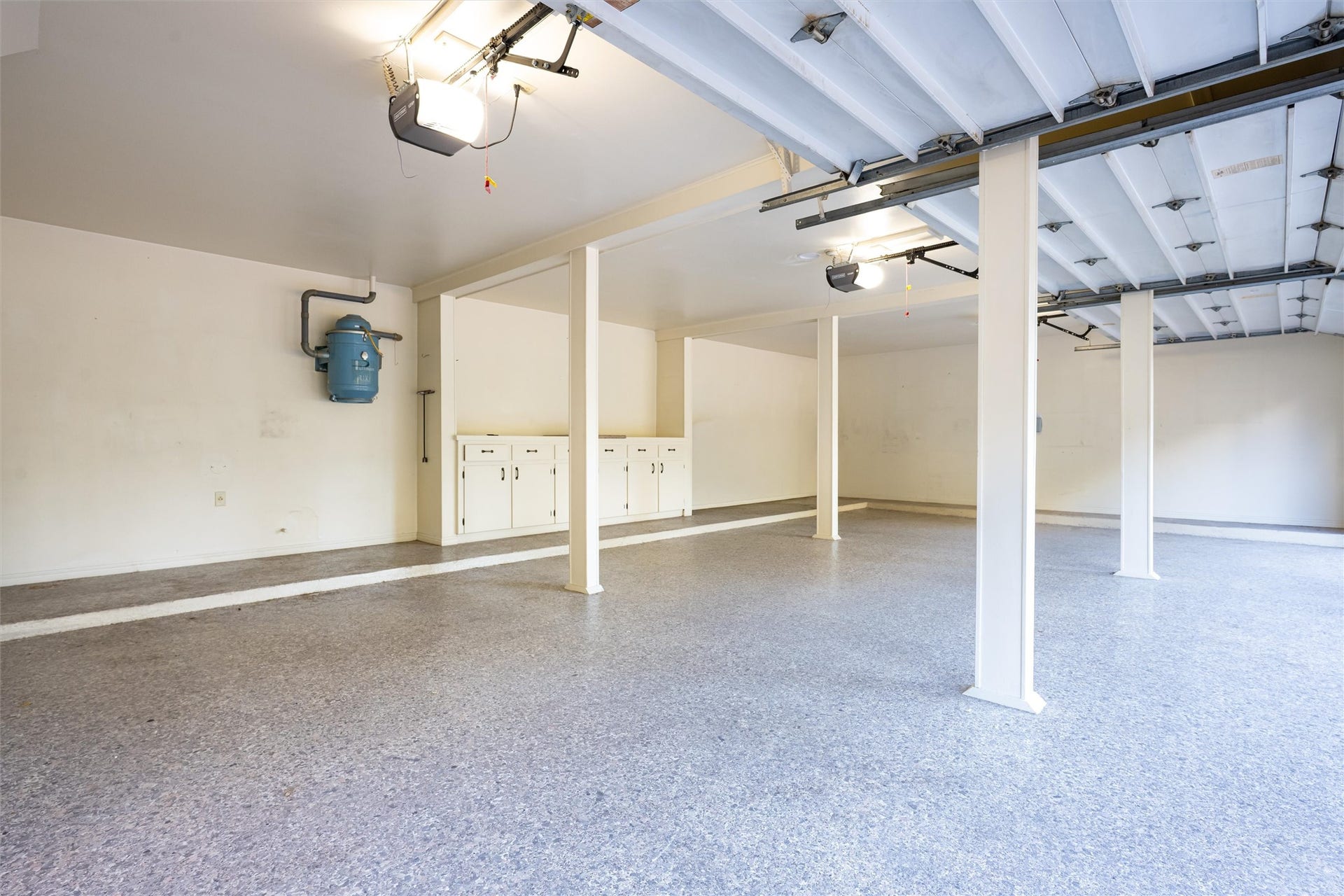 1715 Avenue D, Katy, TX 77493 The oversized three-car garage flaunts durable epoxy flooring, built-in storage cabinetry and two dedicated storage roomsone with cool air system!