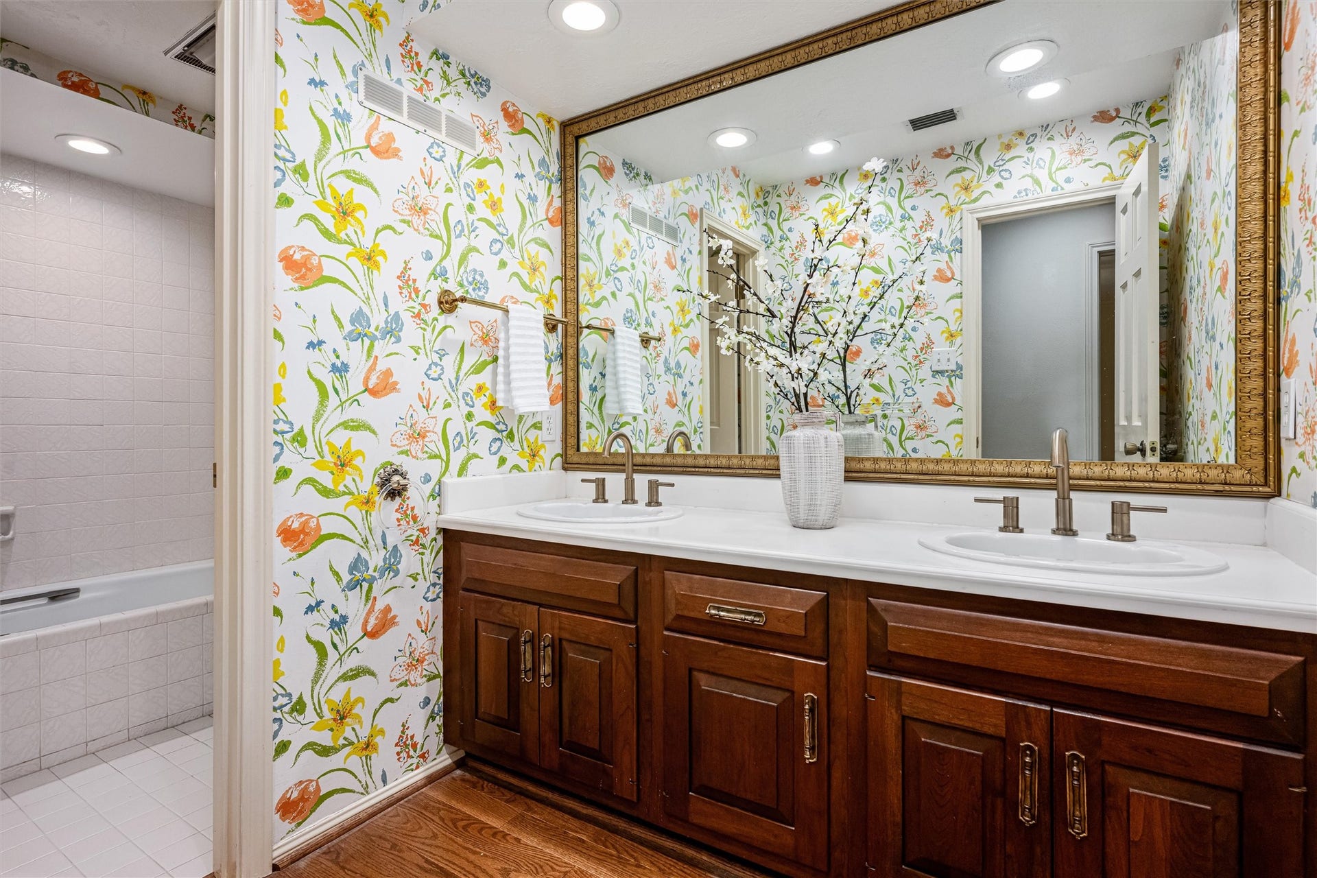 1715 Avenue D, Katy, TX 77493 Full bath with dual vanities, a private toilet area with a tub/shower, provides comfort for family and guests.
