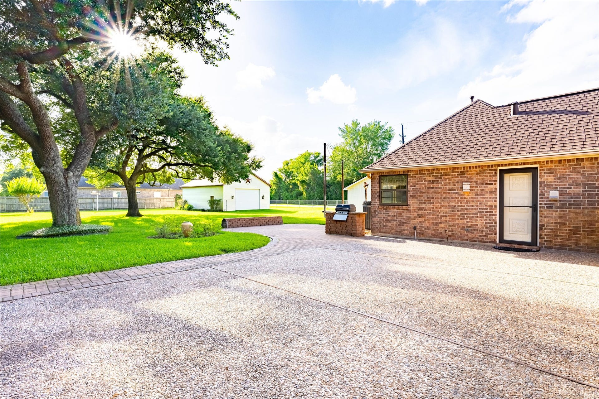1715 Avenue D, Katy, TX 77493 Entertaining is a breeze with this expansive paved patio, built-in gas grill and park-like grounds!