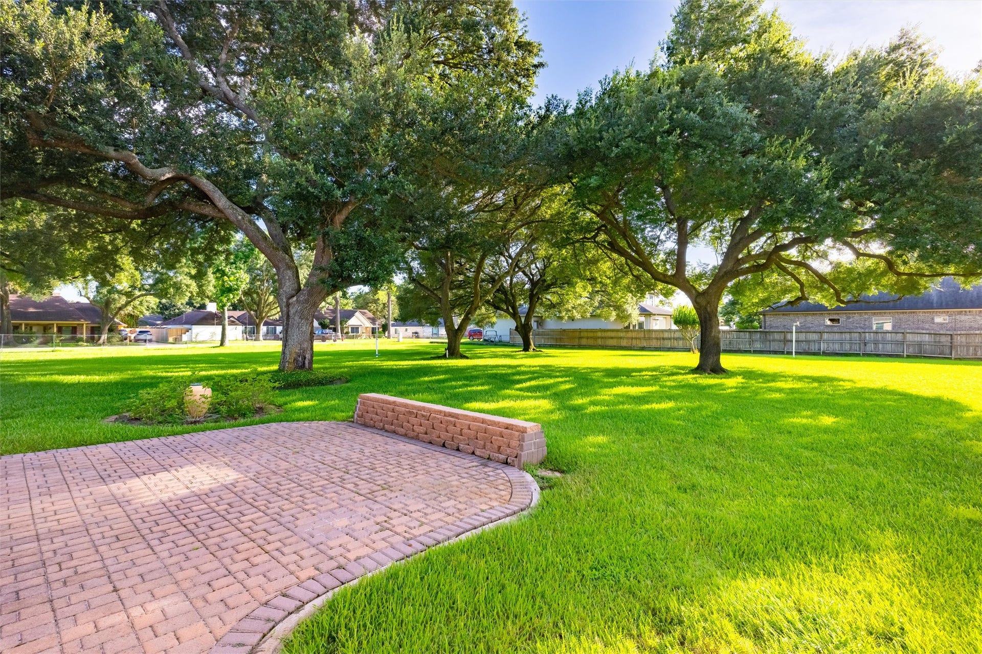 1715 Avenue D, Katy, TX 77493 Towering oaks, sweeping paver walkways and lush, green lawns create a park-like backyard for your peaceful relaxation and unforgettable gatherings.