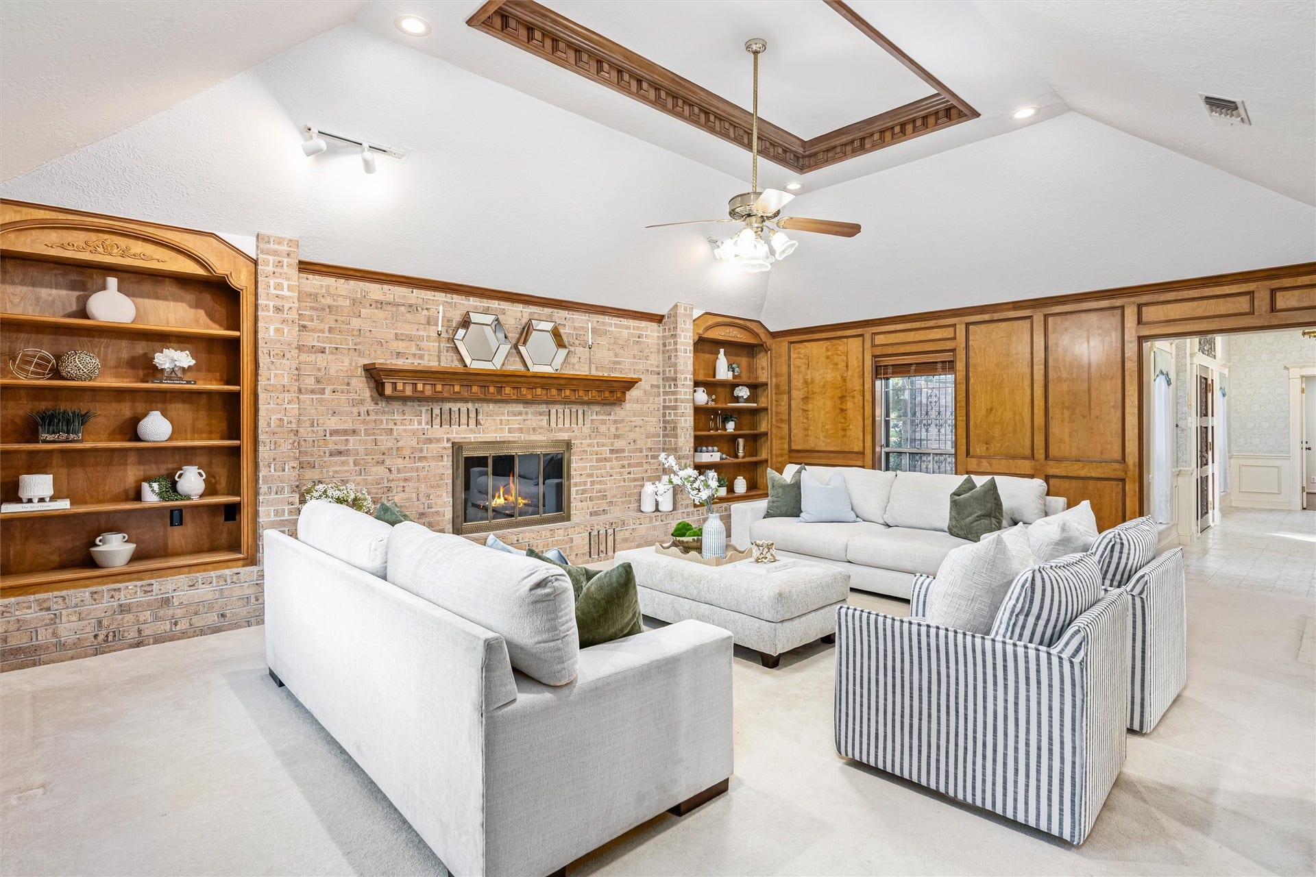 1715 Avenue D, Katy, TX 77493 A second perspective illustrates the custom recessed ceiling detail and the seamless flow connecting the family room to the grand entry and surrounding living spaces.