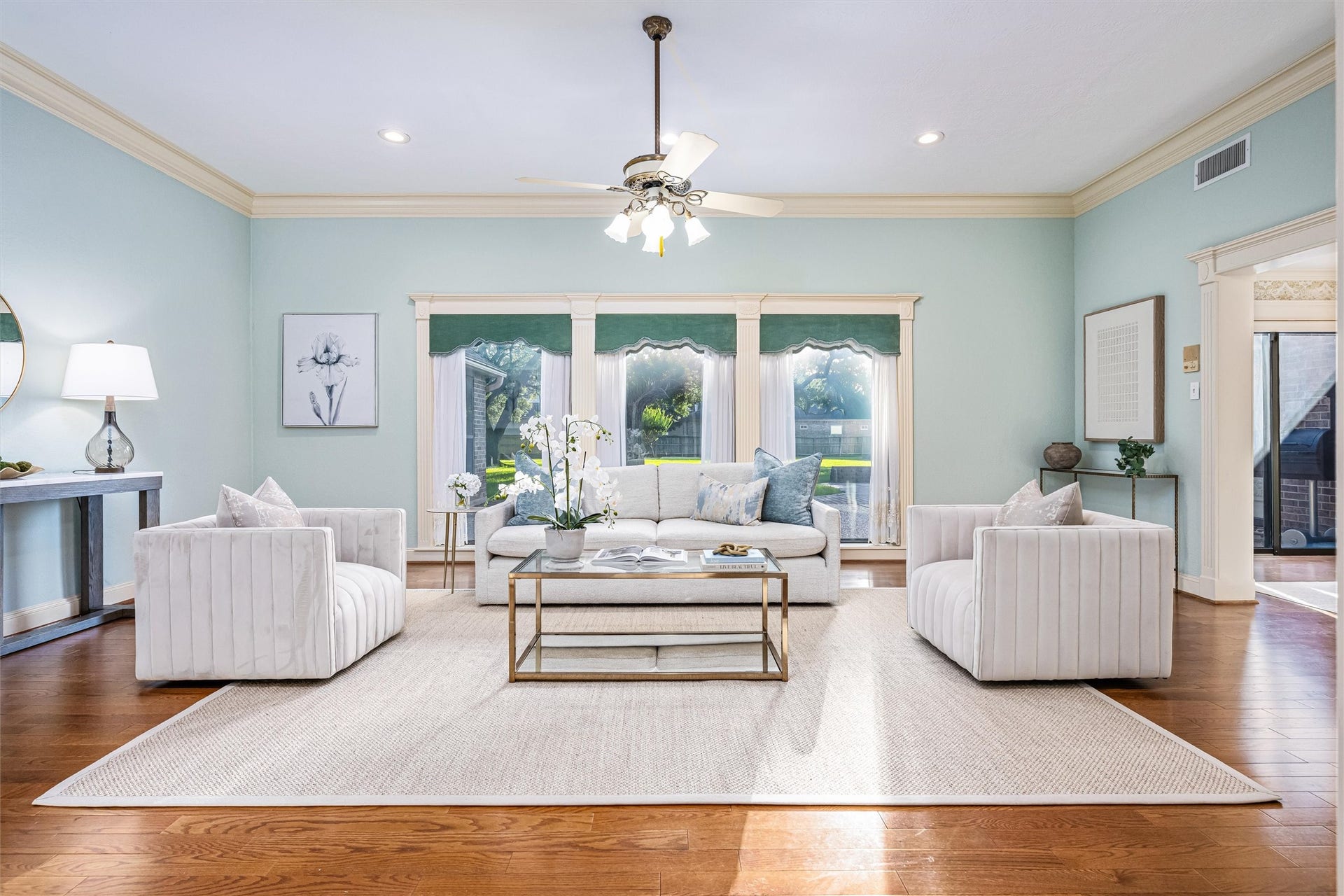 1715 Avenue D, Katy, TX 77493 Formal living room with hardwood floors and oversized windows providing stunning views of the surrounding property.