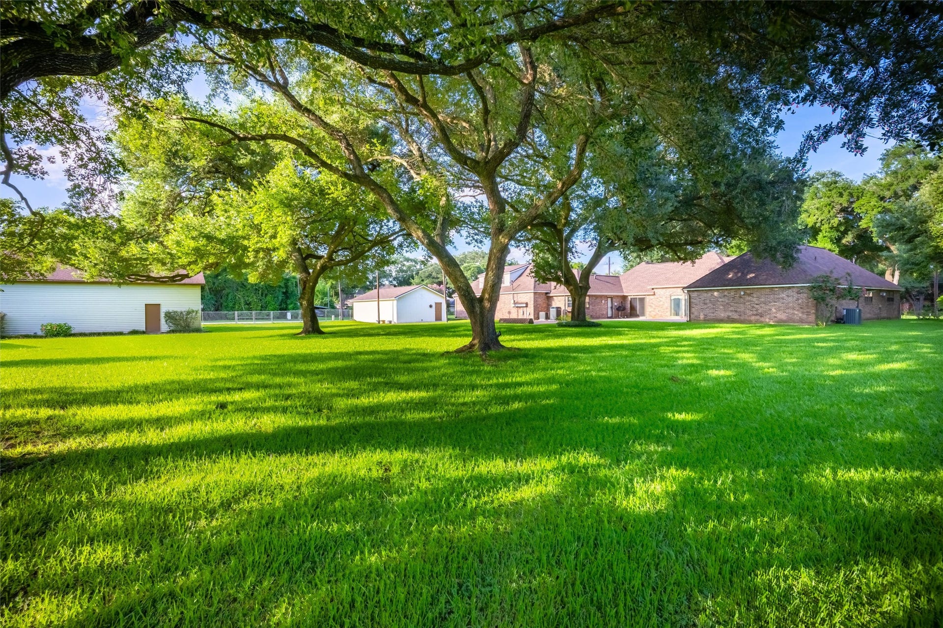 1715 Avenue D, Katy, TX 77493 The sprawling lawn provides plenty of room for a garden swing, outdoor games, or simply relaxing beneath the property's signature oaks.