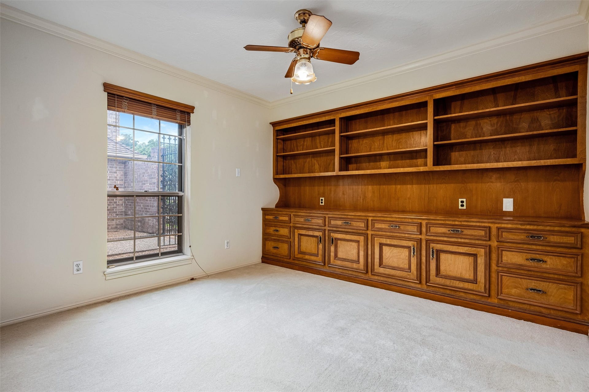 1715 Avenue D, Katy, TX 77493 Custom built-ins transform this secondary bedroom into an ideal home office, library or guest room, offering just the right flexibility to suit your lifestyle