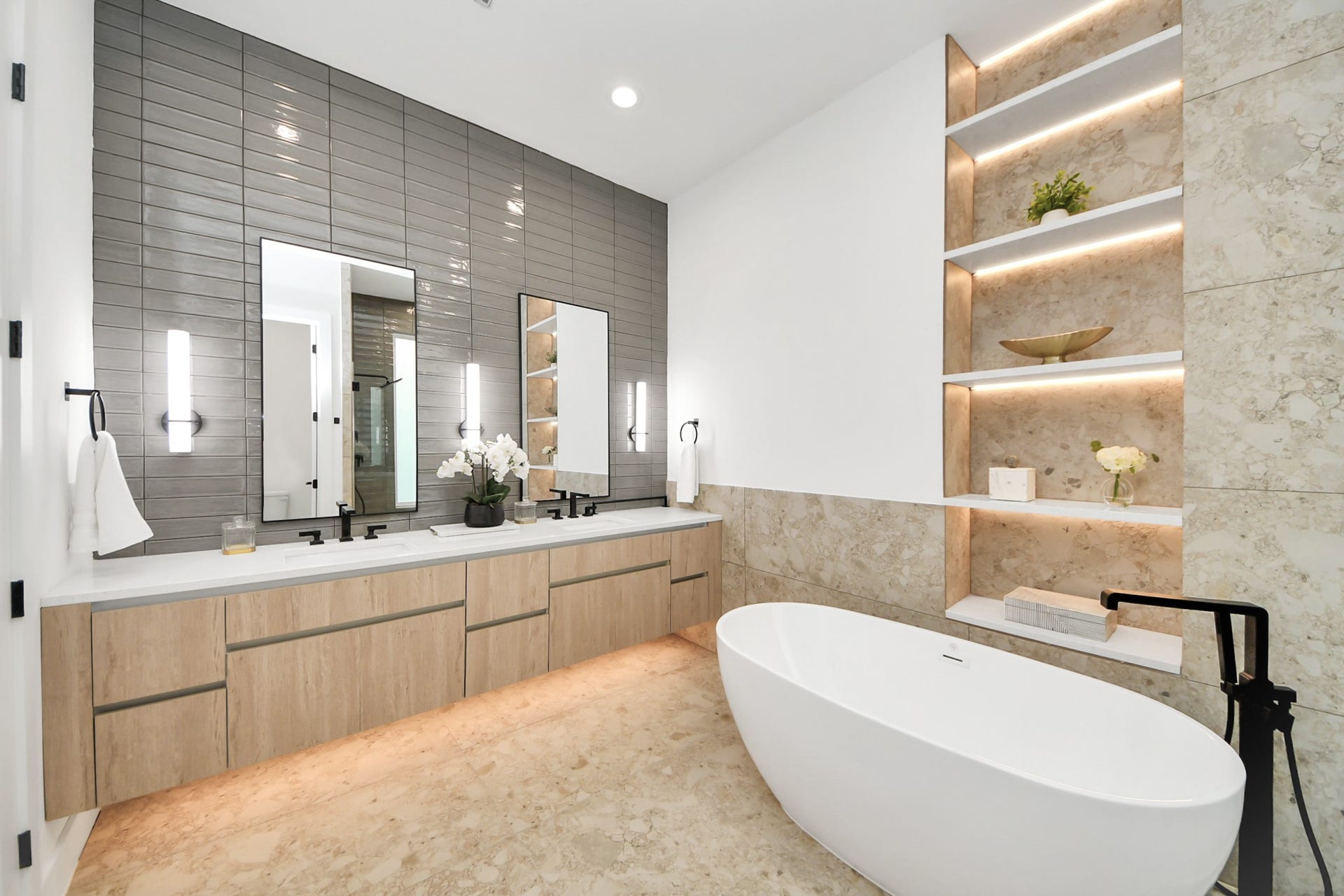 1603 W 25th Street, Houston, TX 77008 Primary bathroom featuring a double vanity, freestanding tub, and contemporary tilework.