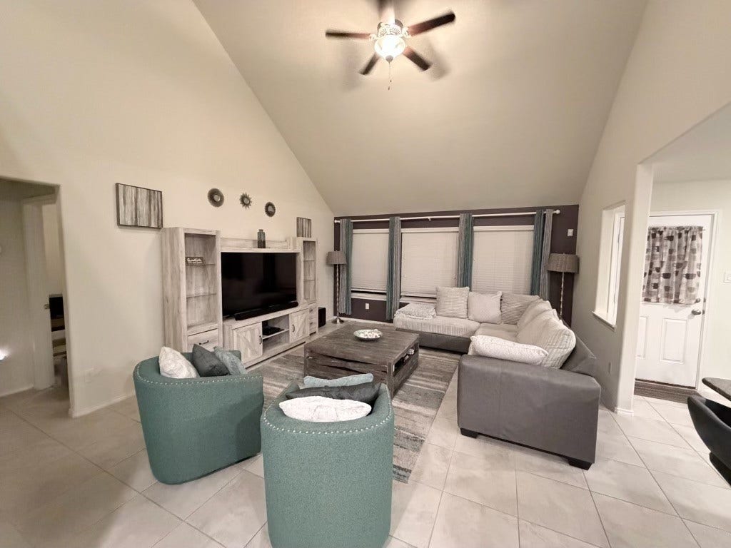 2806 Bretton Woods Drive, Conroe, TX 77301 Unwind in this inviting living space, featuring high ceilings, cozy seating, and a calming atmosphere perfect for relaxation.