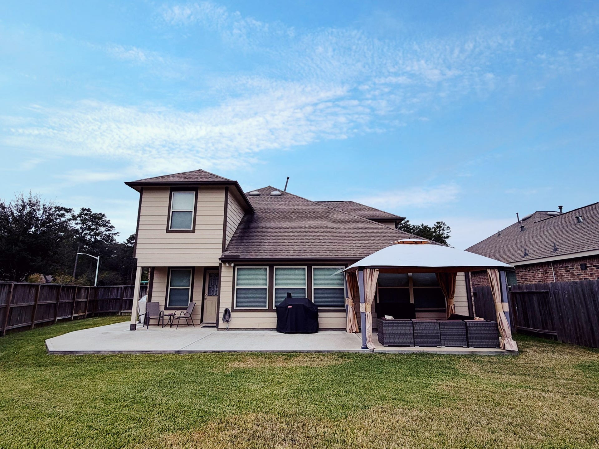 2806 Bretton Woods Drive, Conroe, TX 77301 Charming two-story home with a spacious backyard, featuring a patio area and a covered gazebo. Perfect for outdoor entertaining and relaxation.