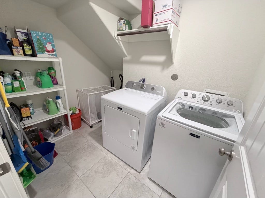 2806 Bretton Woods Drive, Conroe, TX 77301 This perfect utility room:is spacious and organized, featuring modern laundry appliances and ample shelving for all your storage needs.