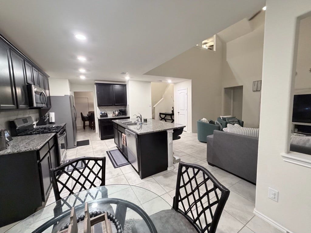 2806 Bretton Woods Drive, Conroe, TX 77301 This home boasts an open, spacious design that seamlessly flows from the modern kitchen to the inviting living area, perfect for effortless living and entertaining.