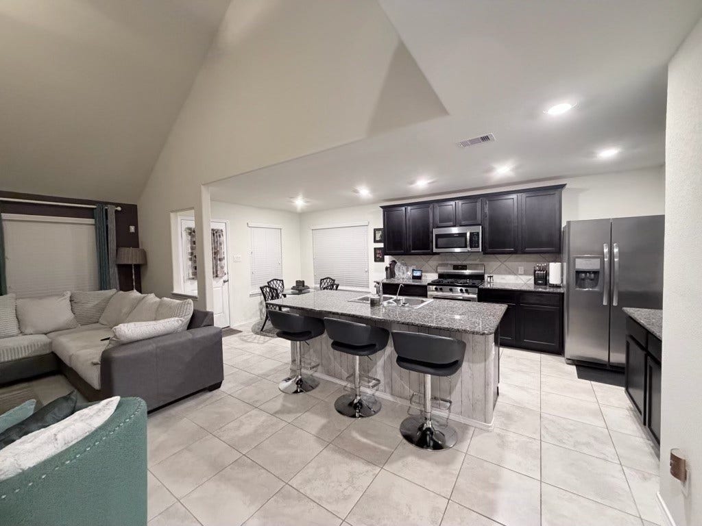 2806 Bretton Woods Drive, Conroe, TX 77301 Discover the perfect smart home that has a open entertaining space in this inviting home, featuring a stylish kitchen with sleek countertops and a spacious living area ideal for gatherings.
